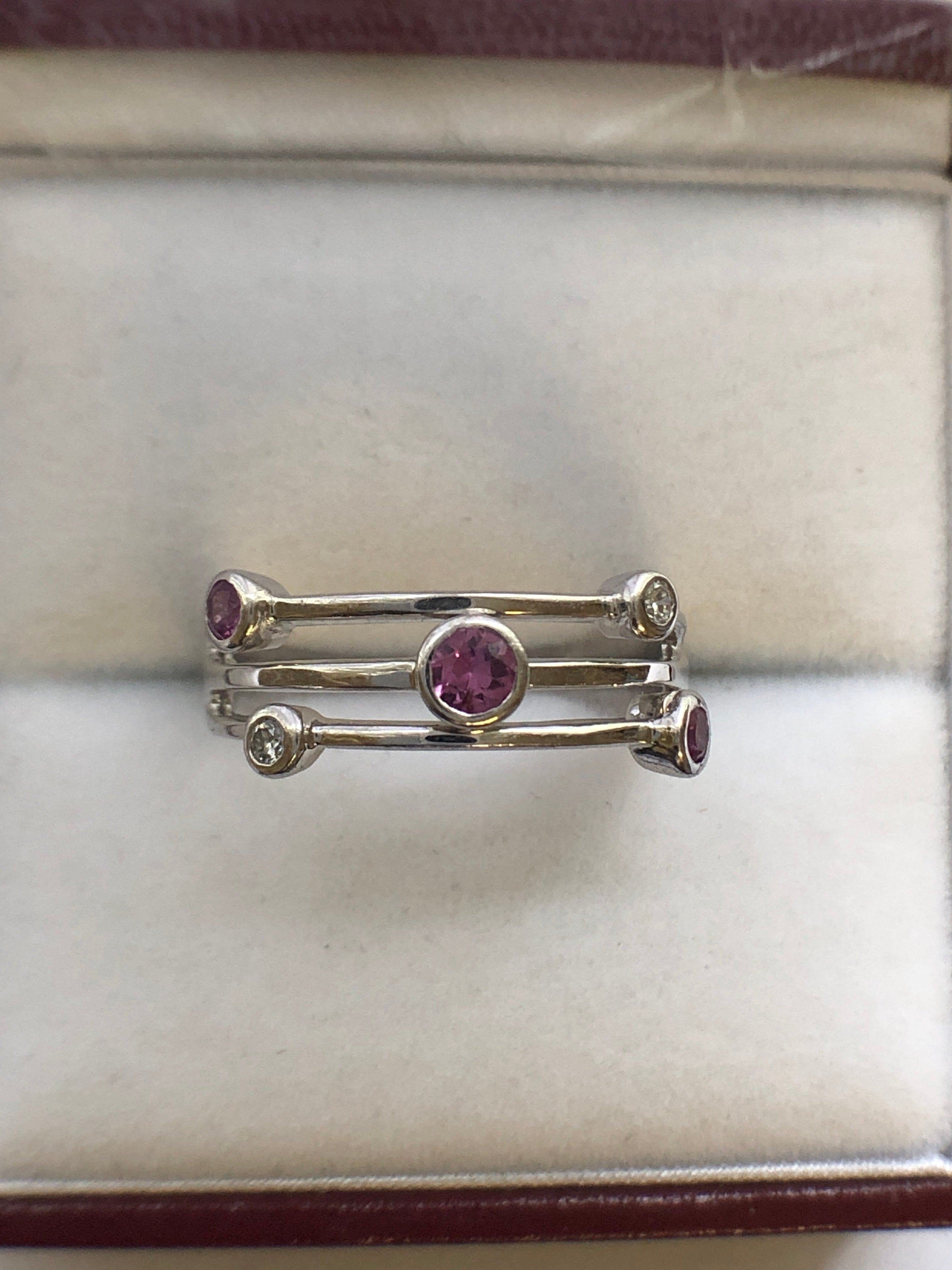 An 18ct white gold pink sapphire and diamond ring