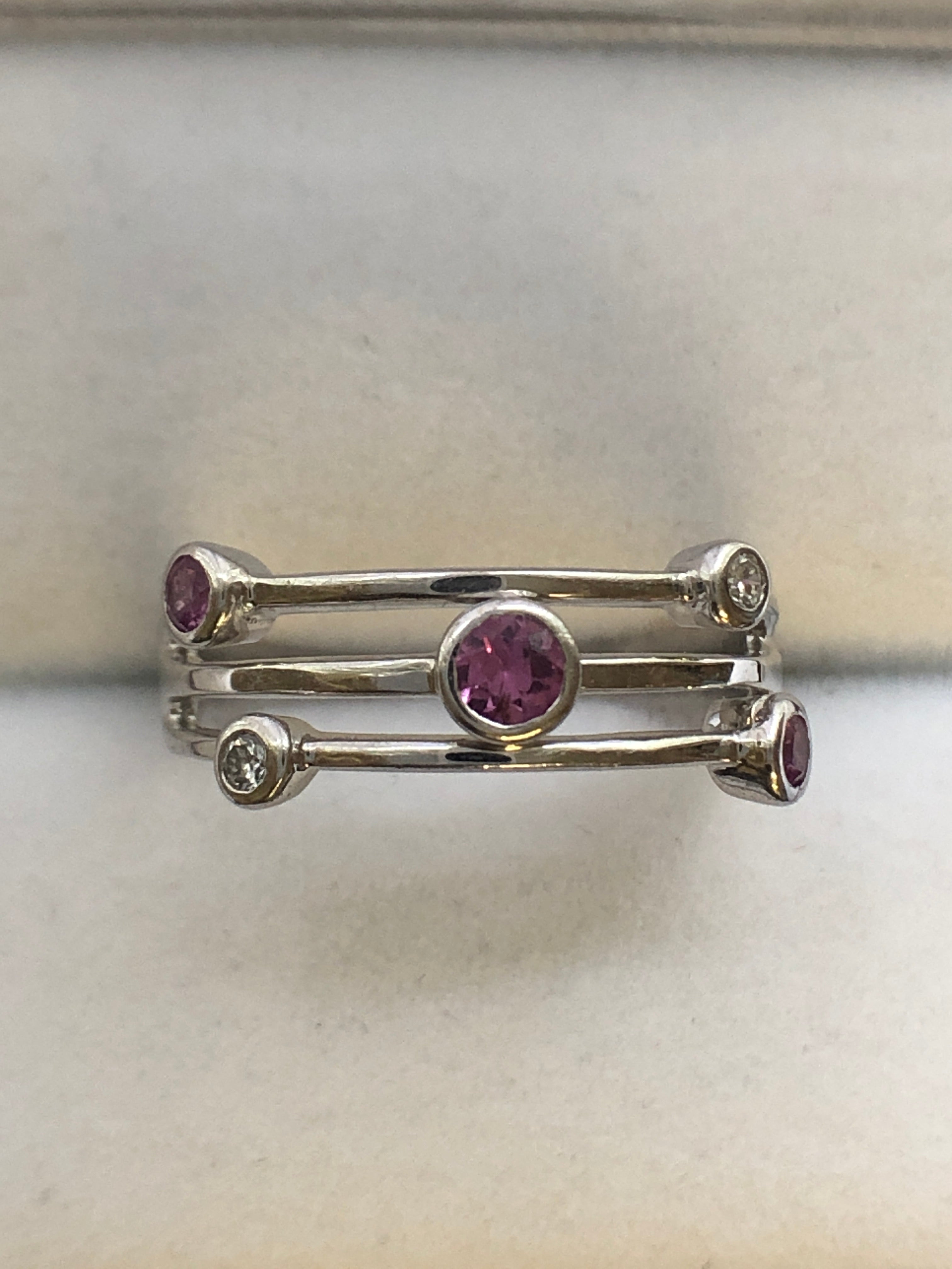 An 18ct white gold pink sapphire and diamond ring