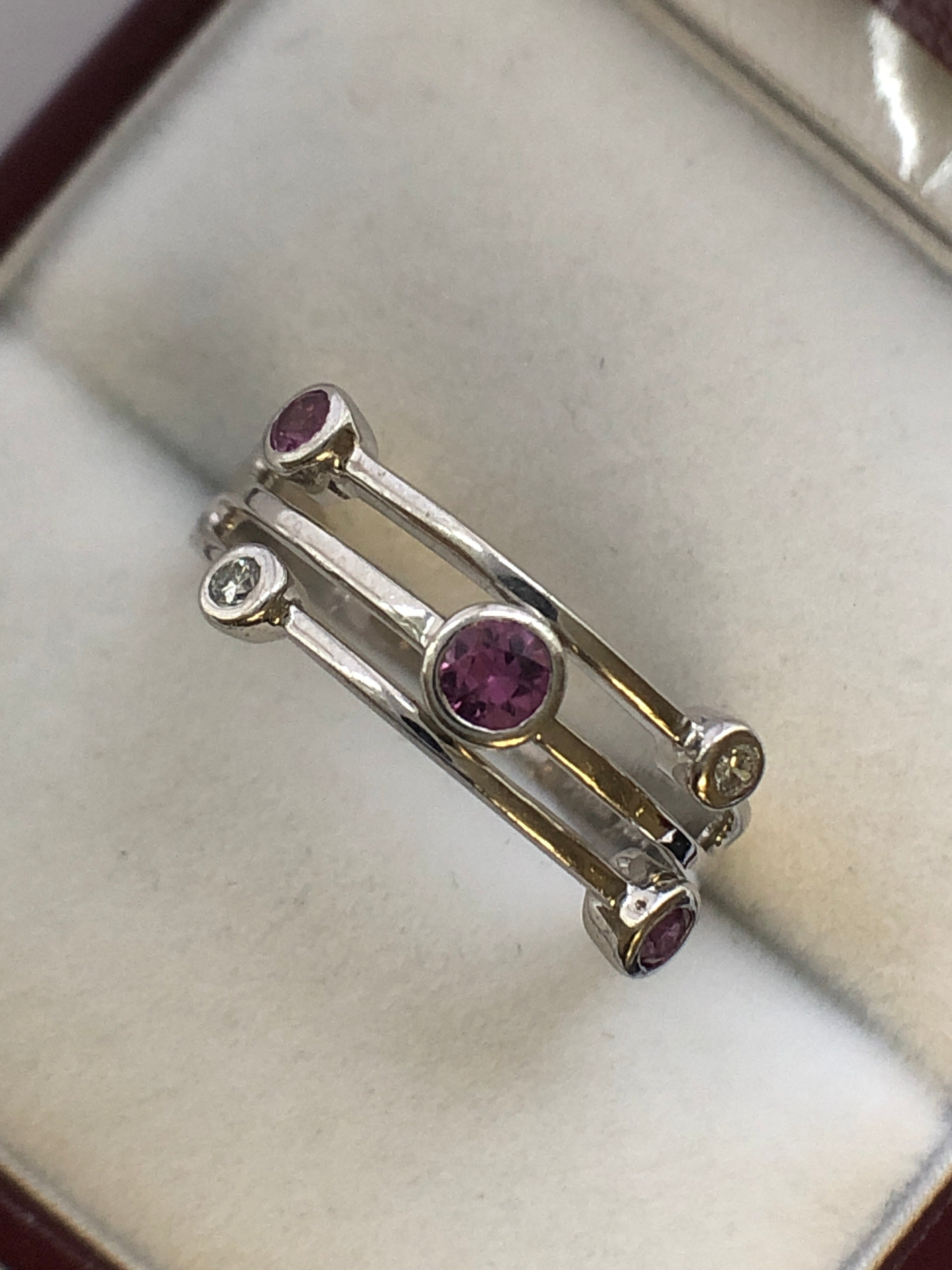An 18ct white gold pink sapphire and diamond ring