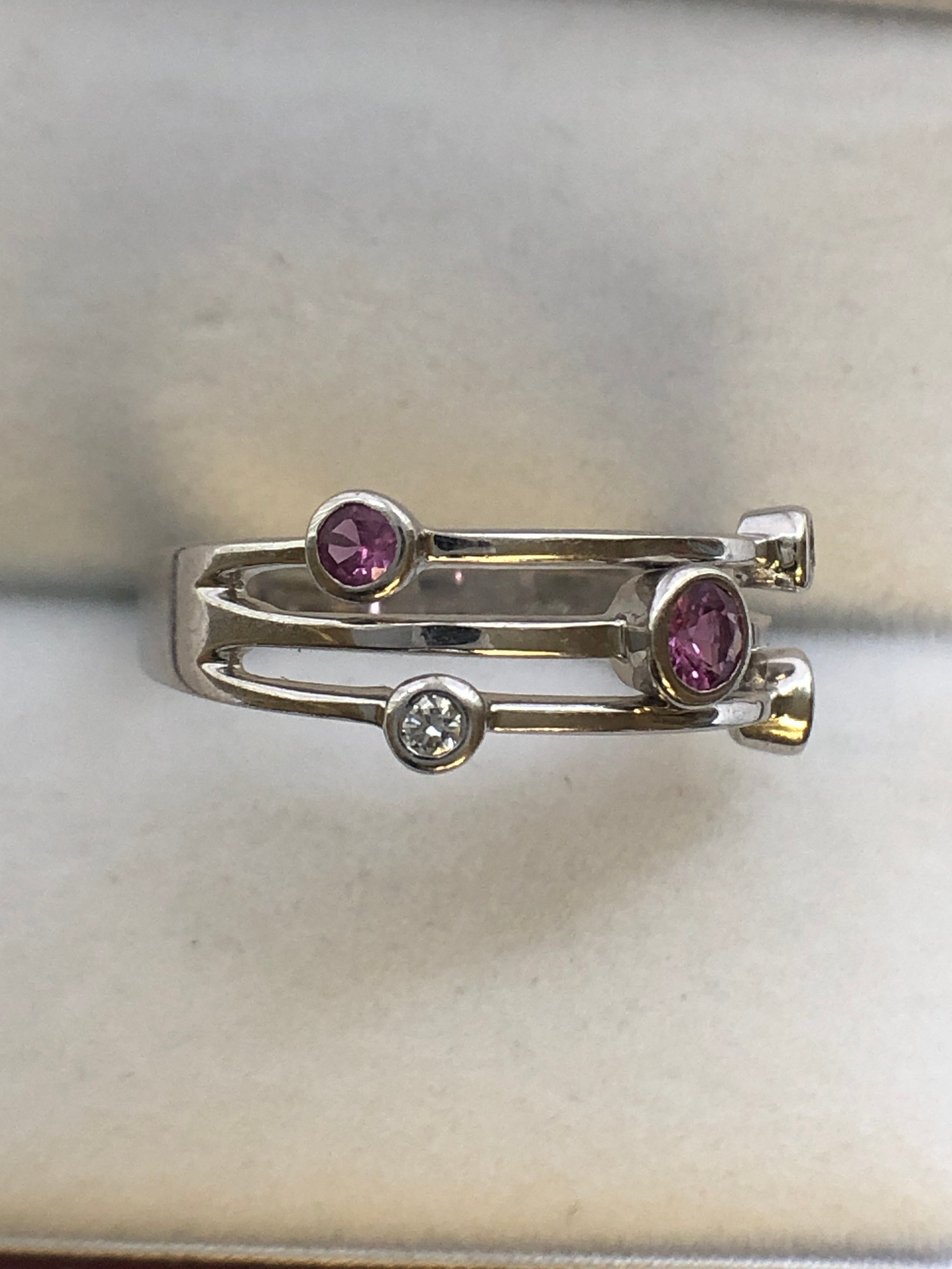 An 18ct white gold pink sapphire and diamond ring