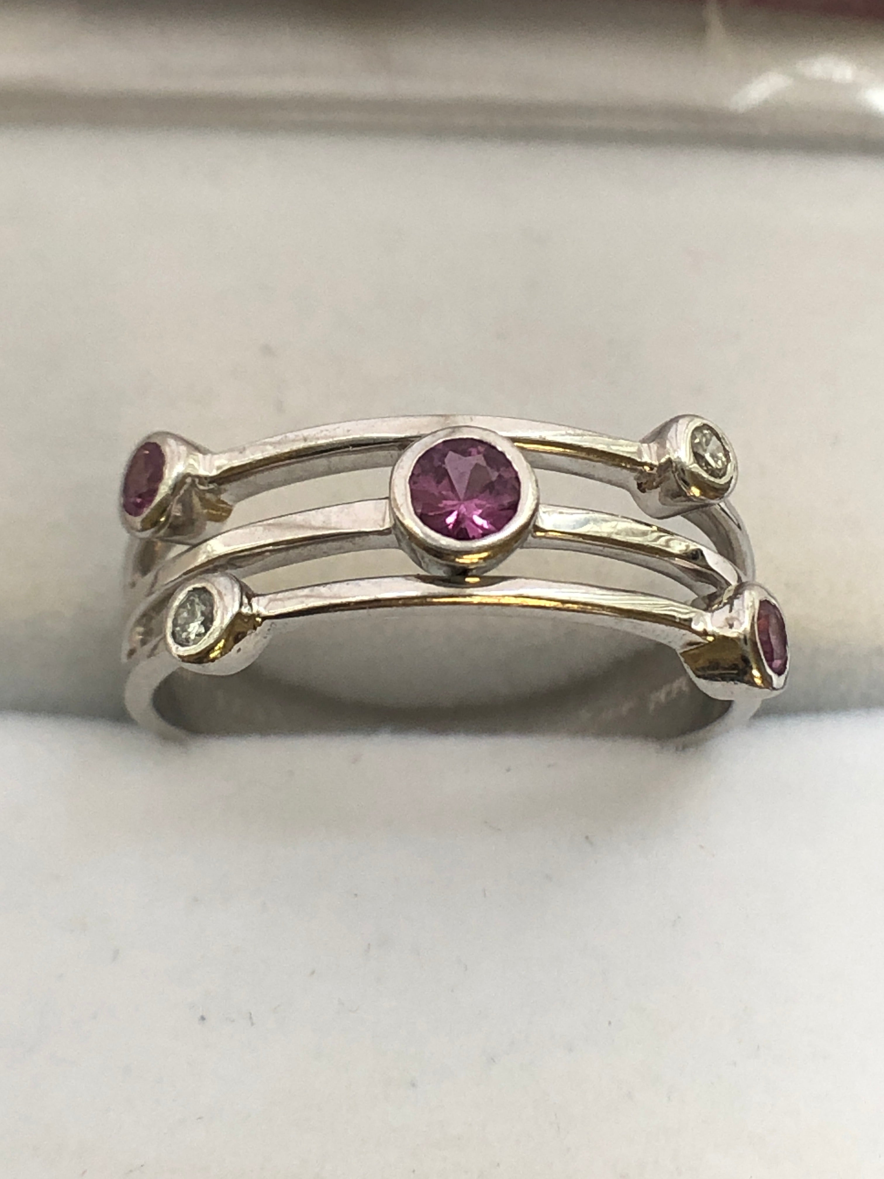 An 18ct white gold pink sapphire and diamond ring
