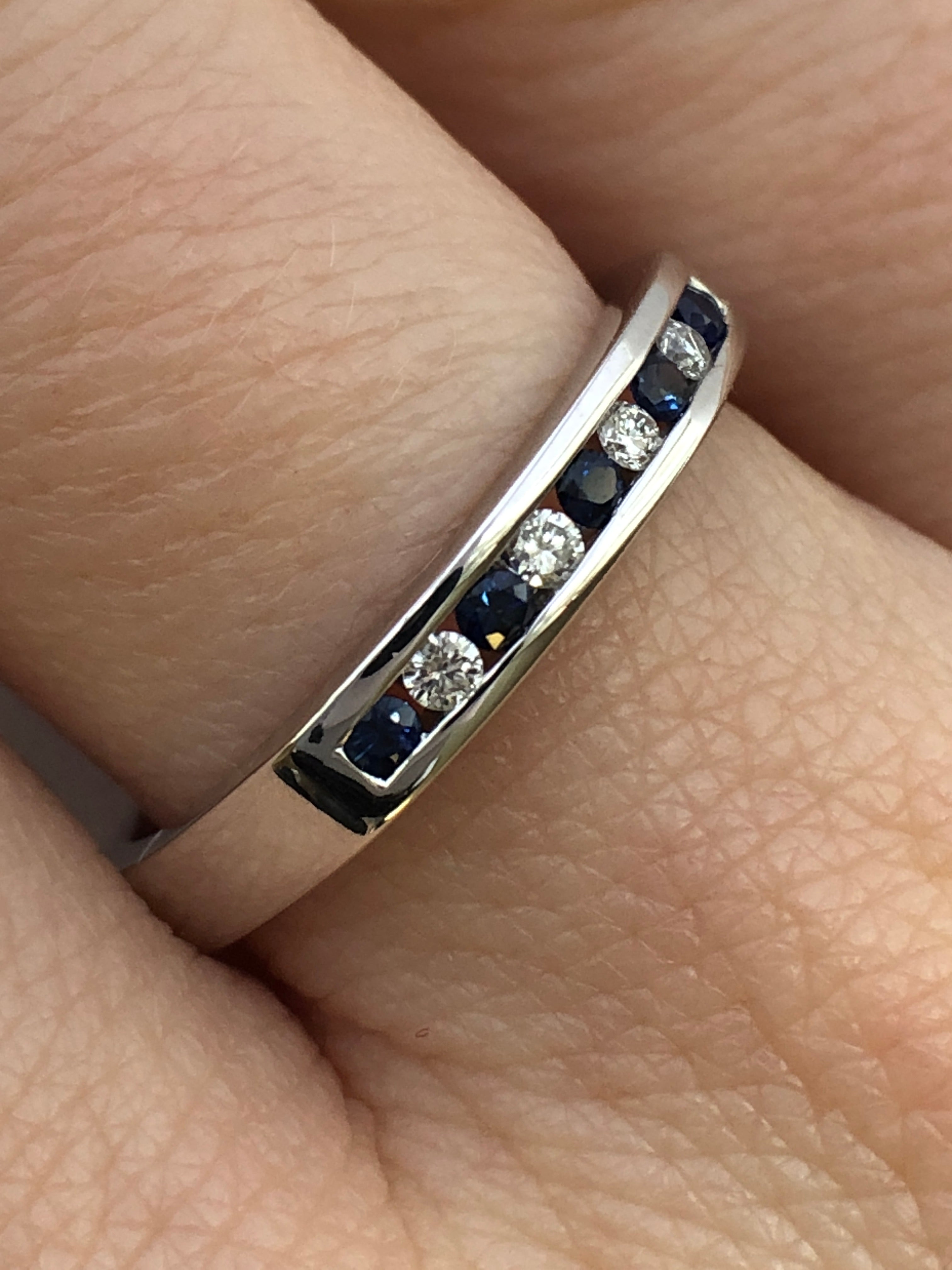 A 9ct white gold sapphire and diamond half eternity ring