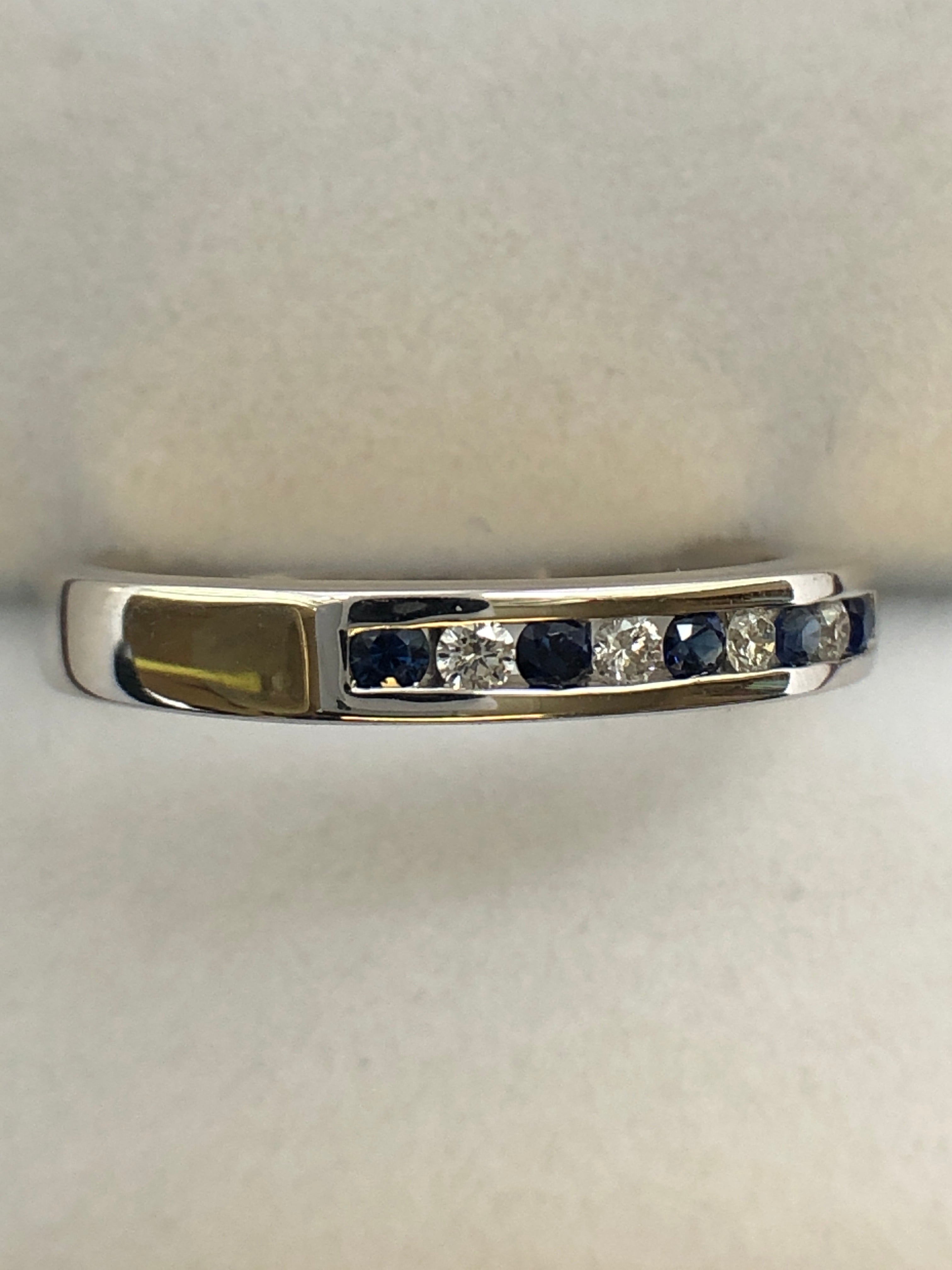 A 9ct white gold sapphire and diamond half eternity ring