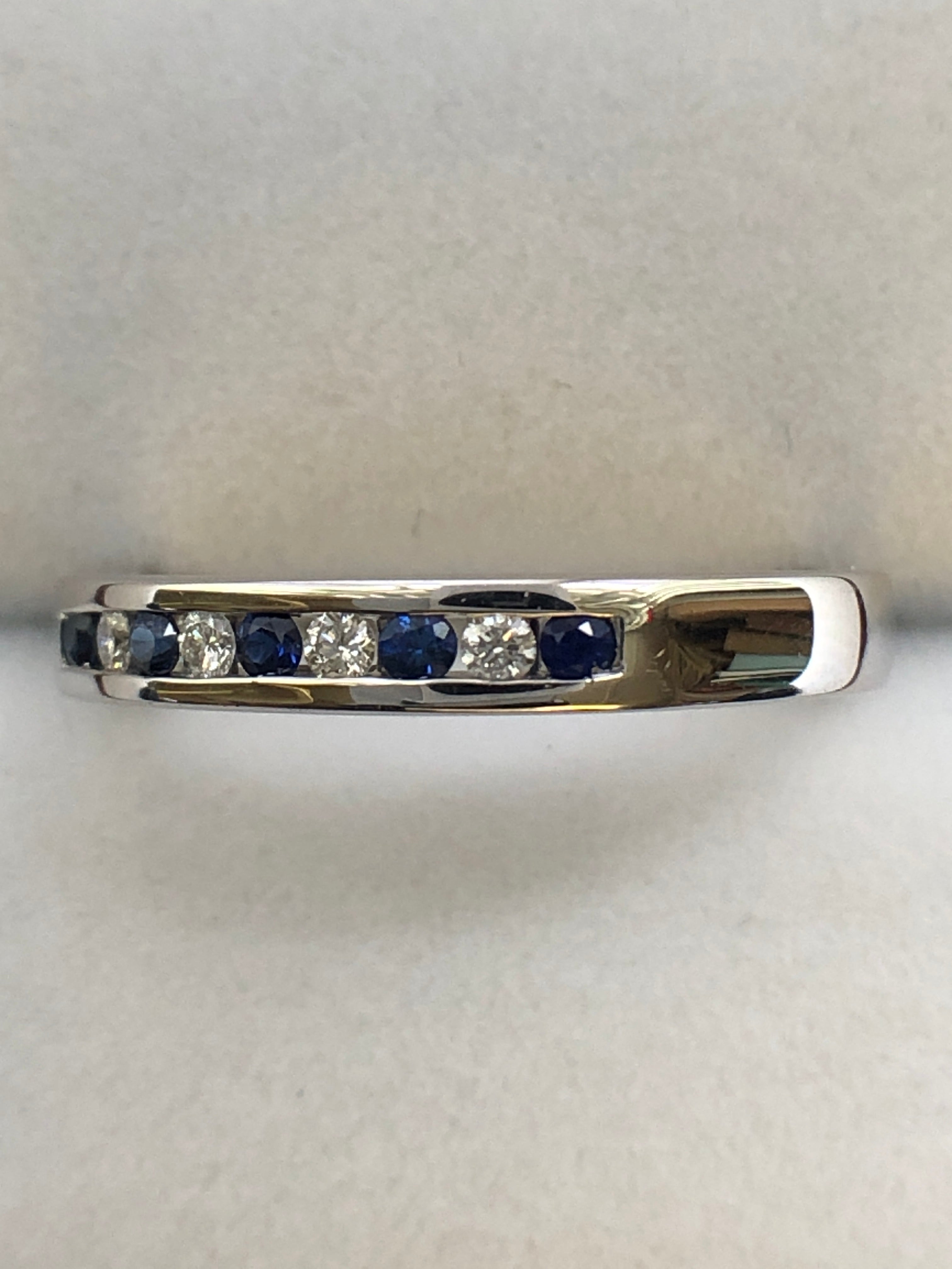 A 9ct white gold sapphire and diamond half eternity ring