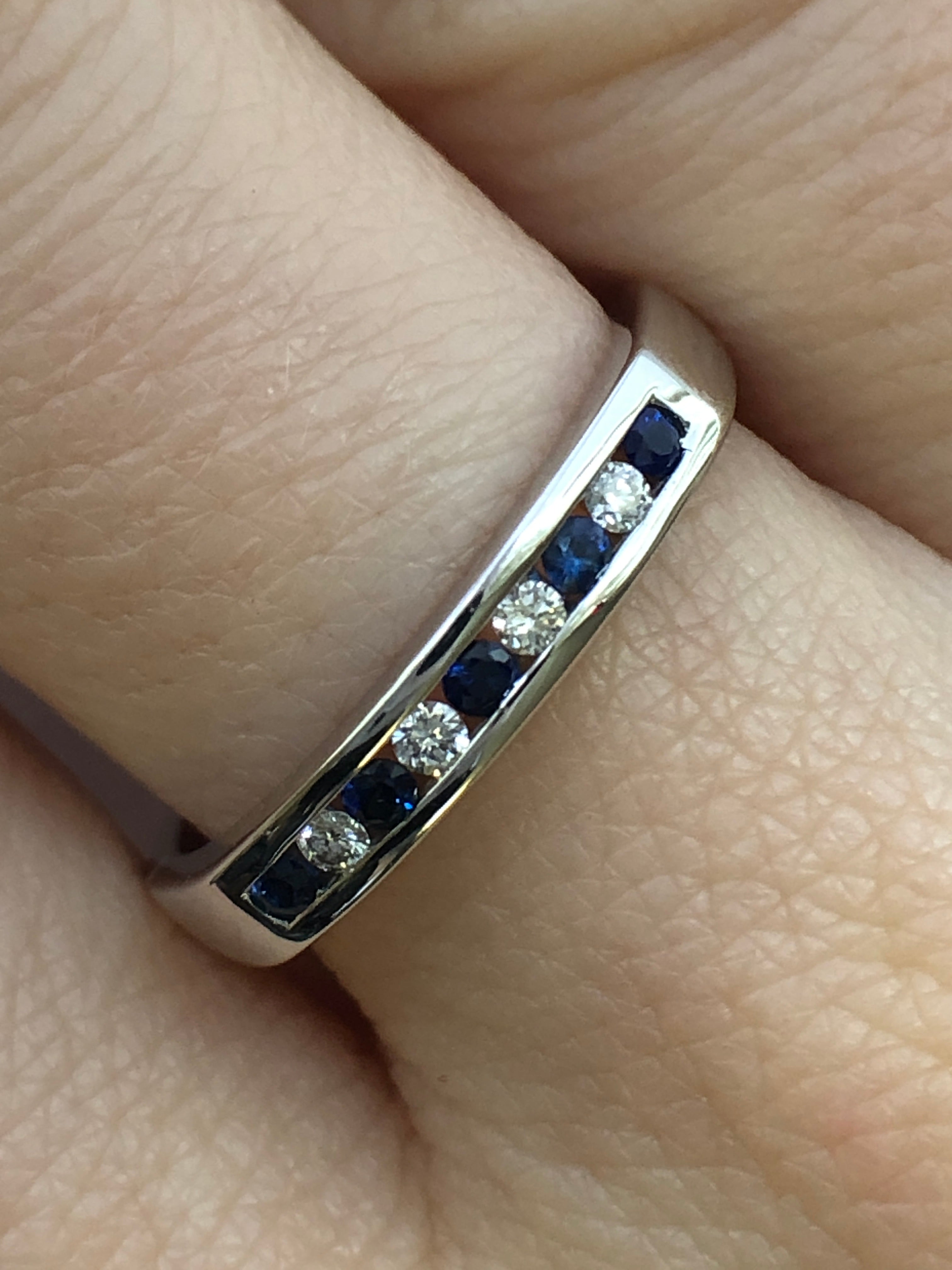 A 9ct white gold sapphire and diamond half eternity ring