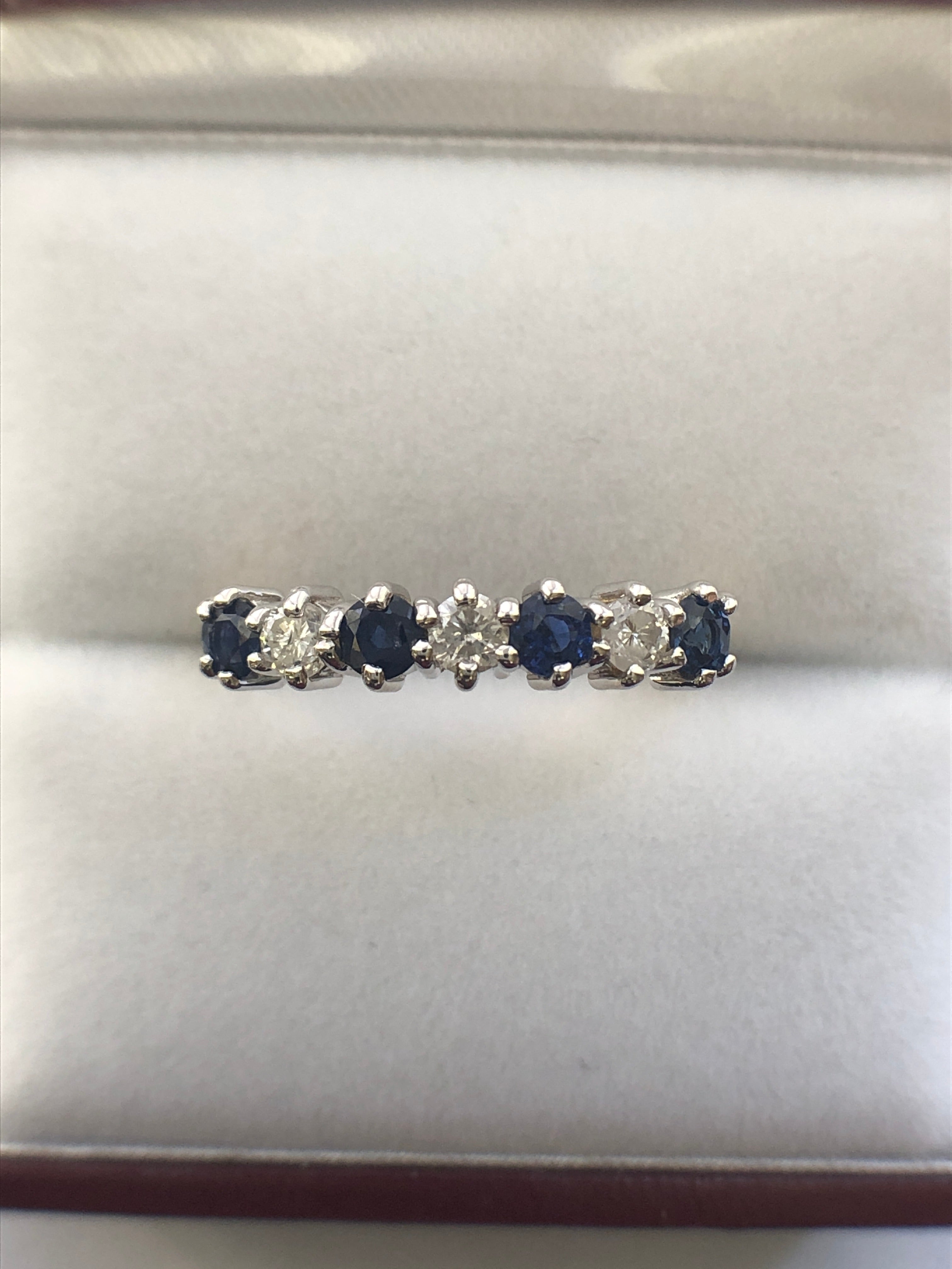 An 18ct gold sapphire and diamond seven stone ring