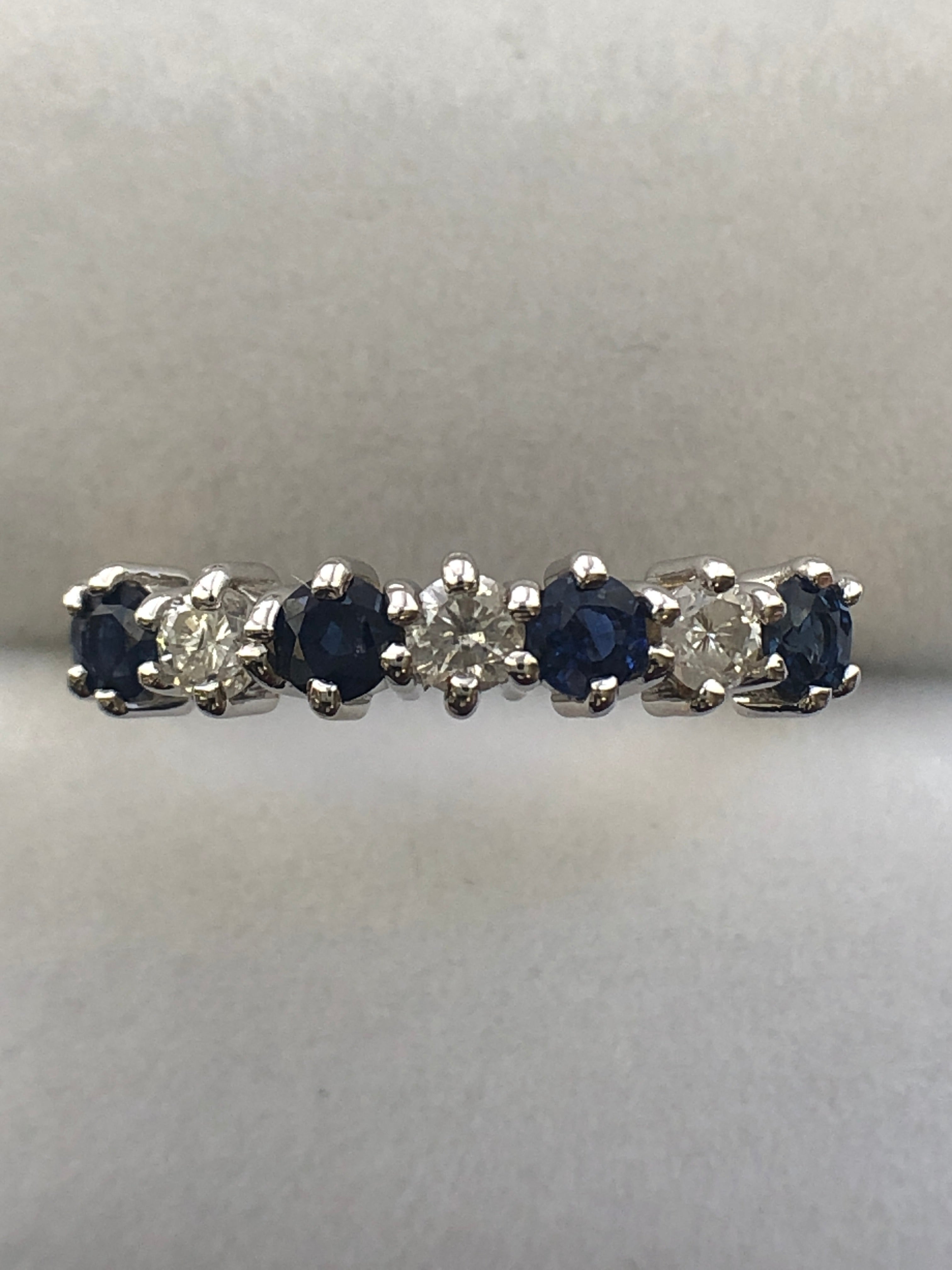 An 18ct gold sapphire and diamond seven stone ring