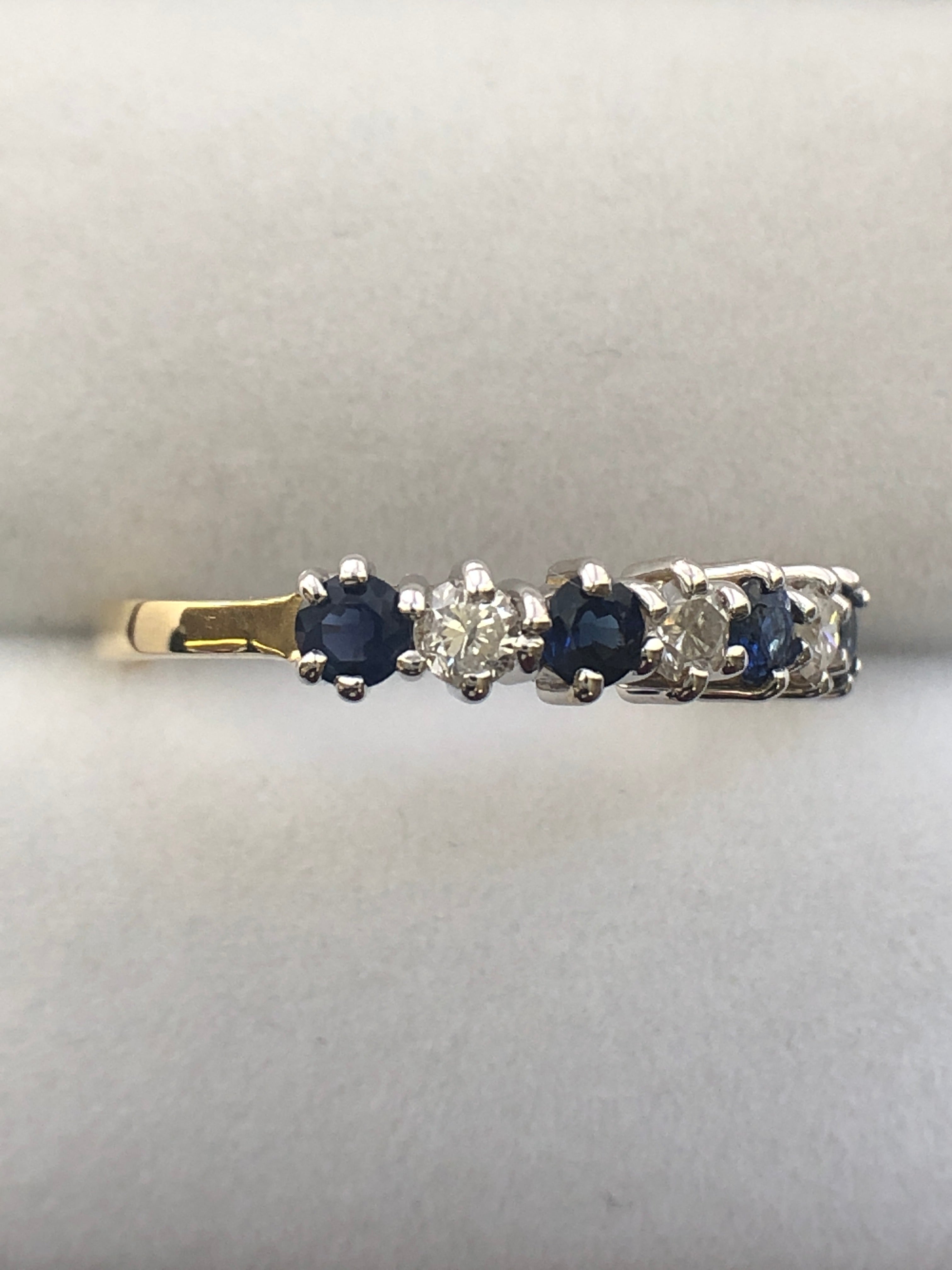 An 18ct gold sapphire and diamond seven stone ring