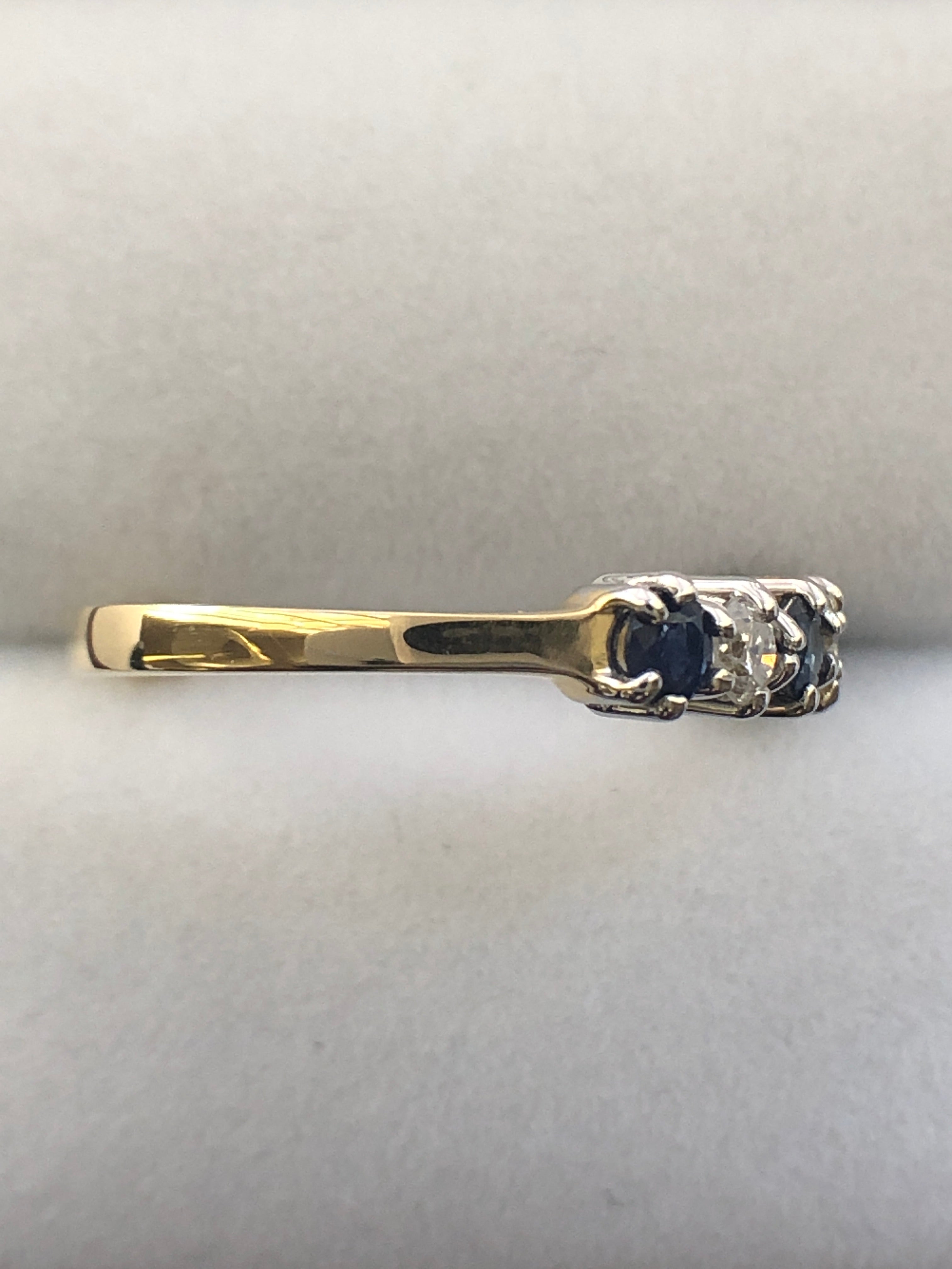 An 18ct gold sapphire and diamond seven stone ring