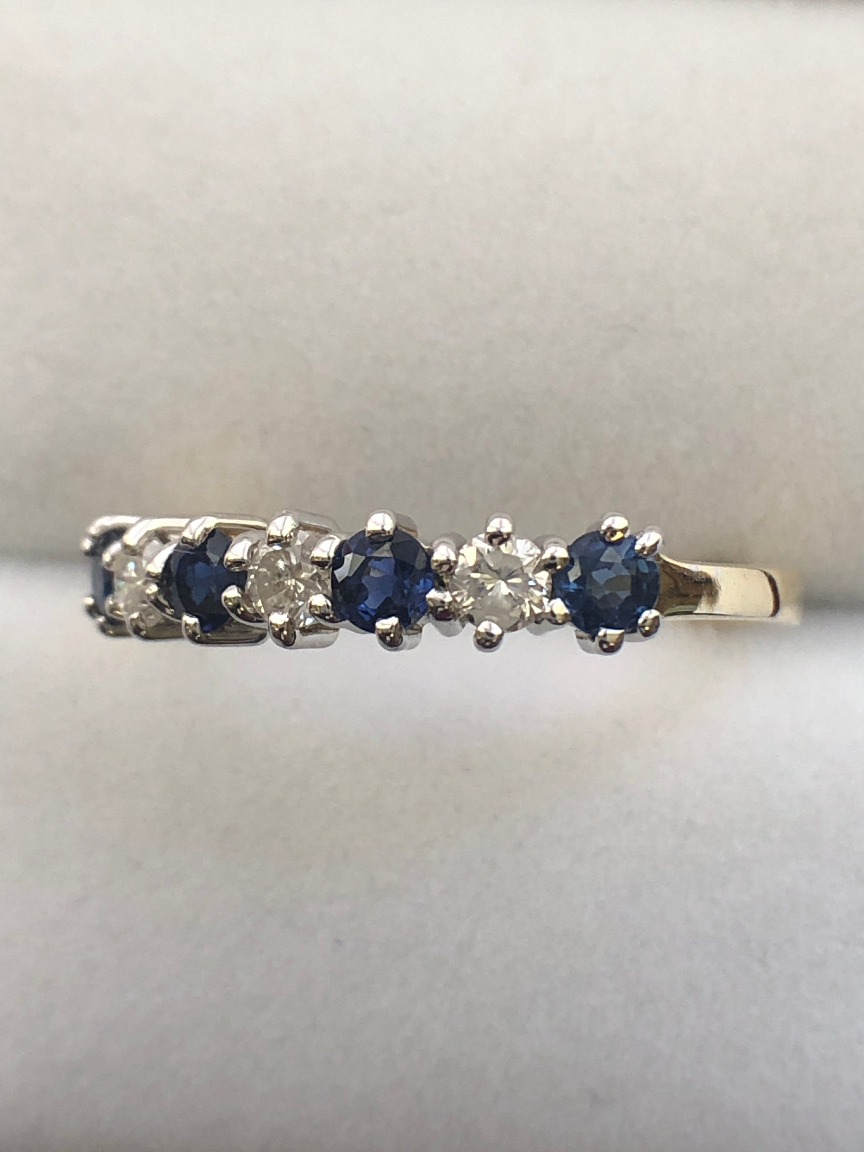 An 18ct gold sapphire and diamond seven stone ring