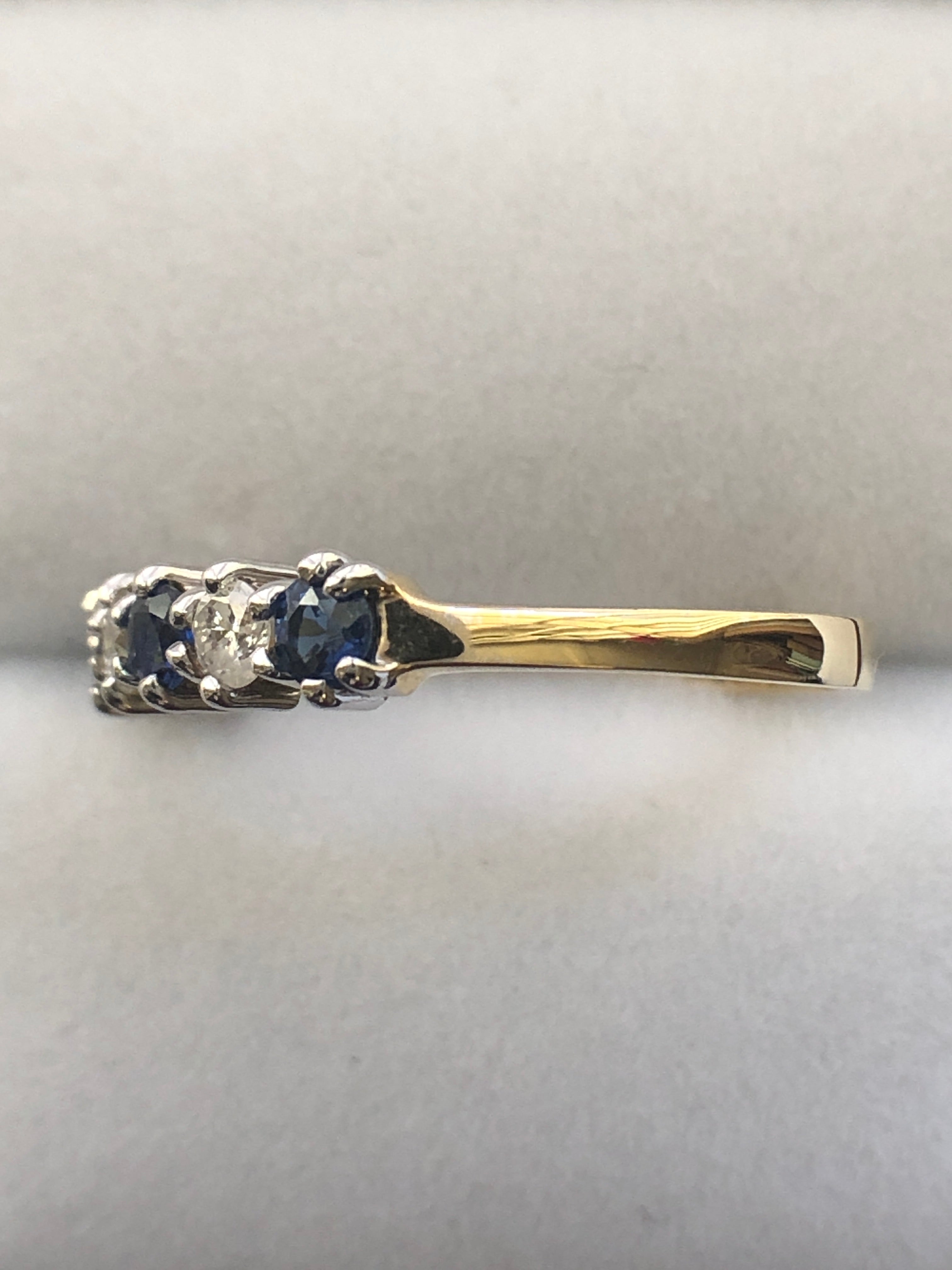An 18ct gold sapphire and diamond seven stone ring
