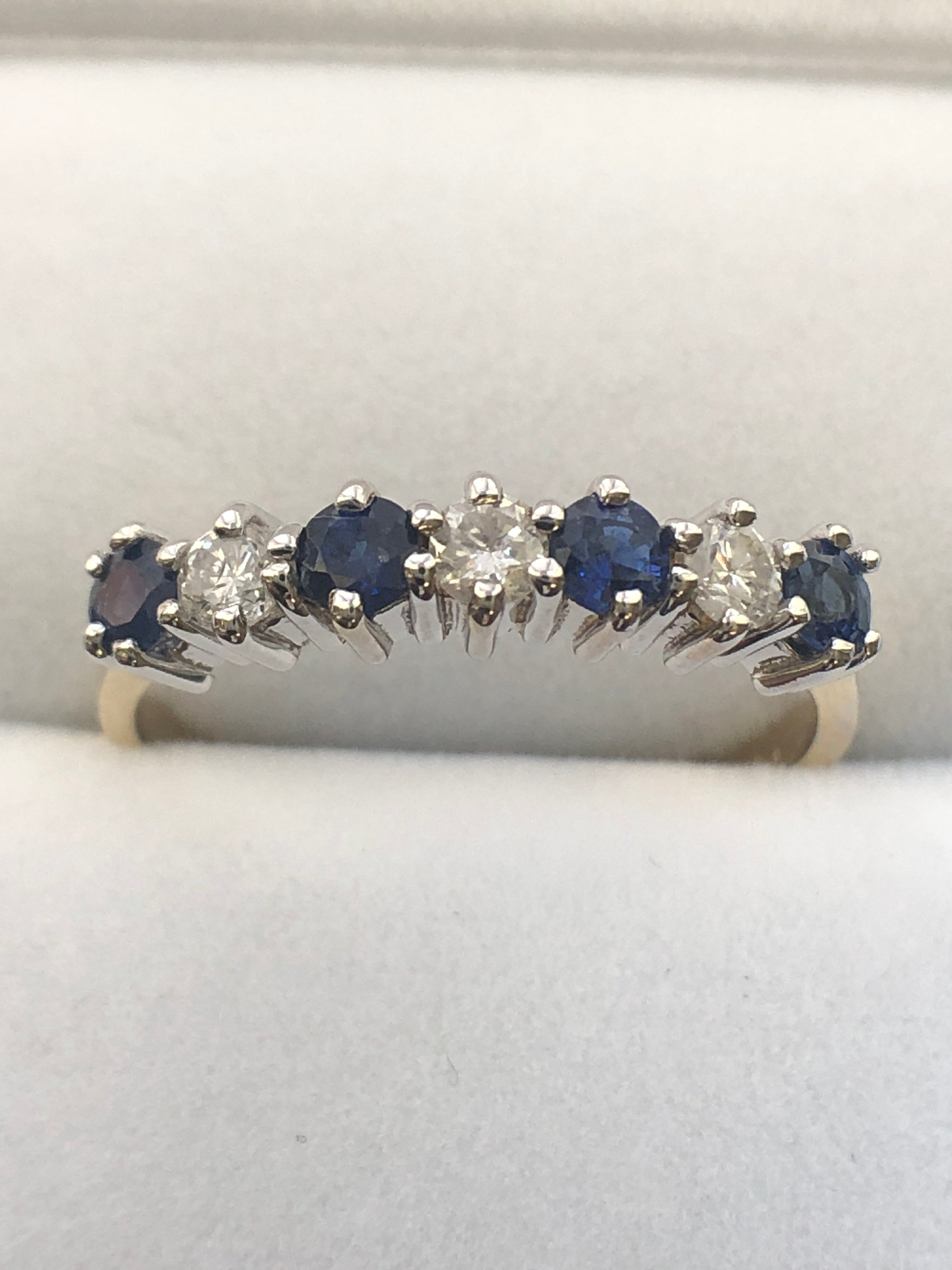 An 18ct gold sapphire and diamond seven stone ring
