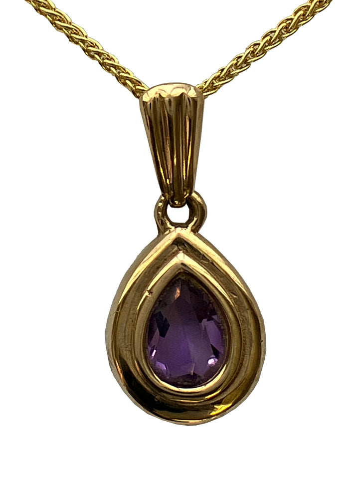 A 9ct gold amethyst pendant on a 9ct gold chain