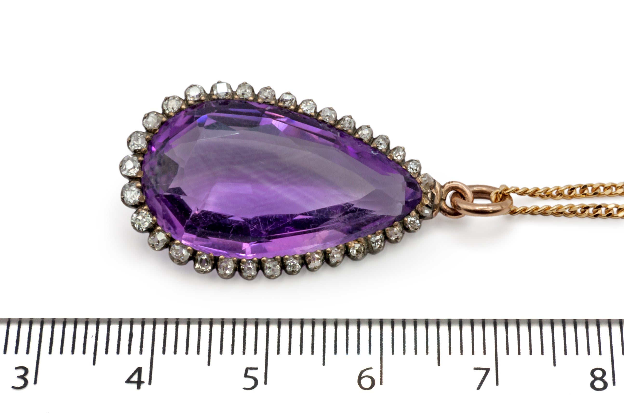A 9ct yellow gold and silver amethyst and diamond pendant.