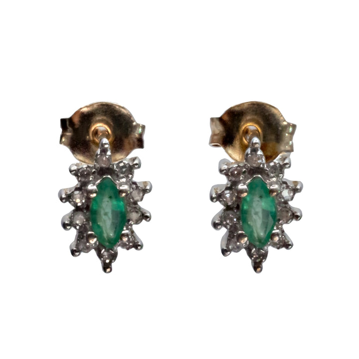 A 9ct white gold emerald and diamond earring.