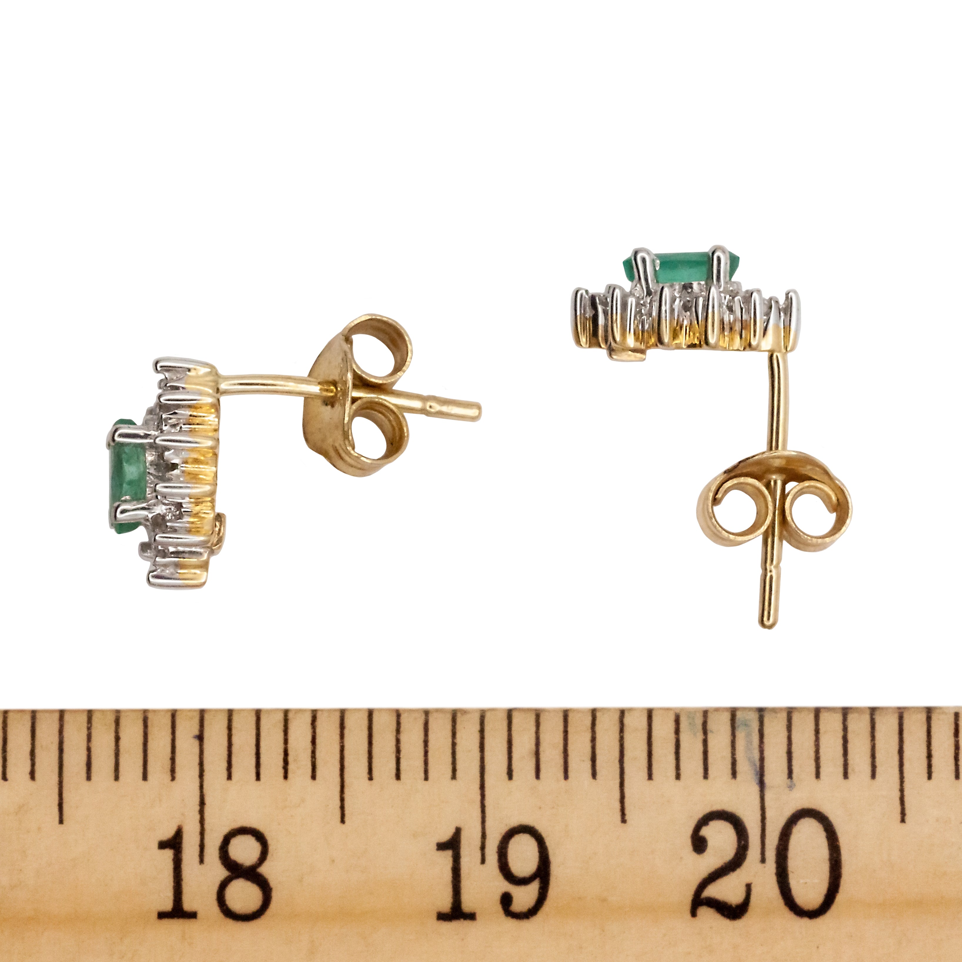 A 9ct white gold emerald and diamond earring.