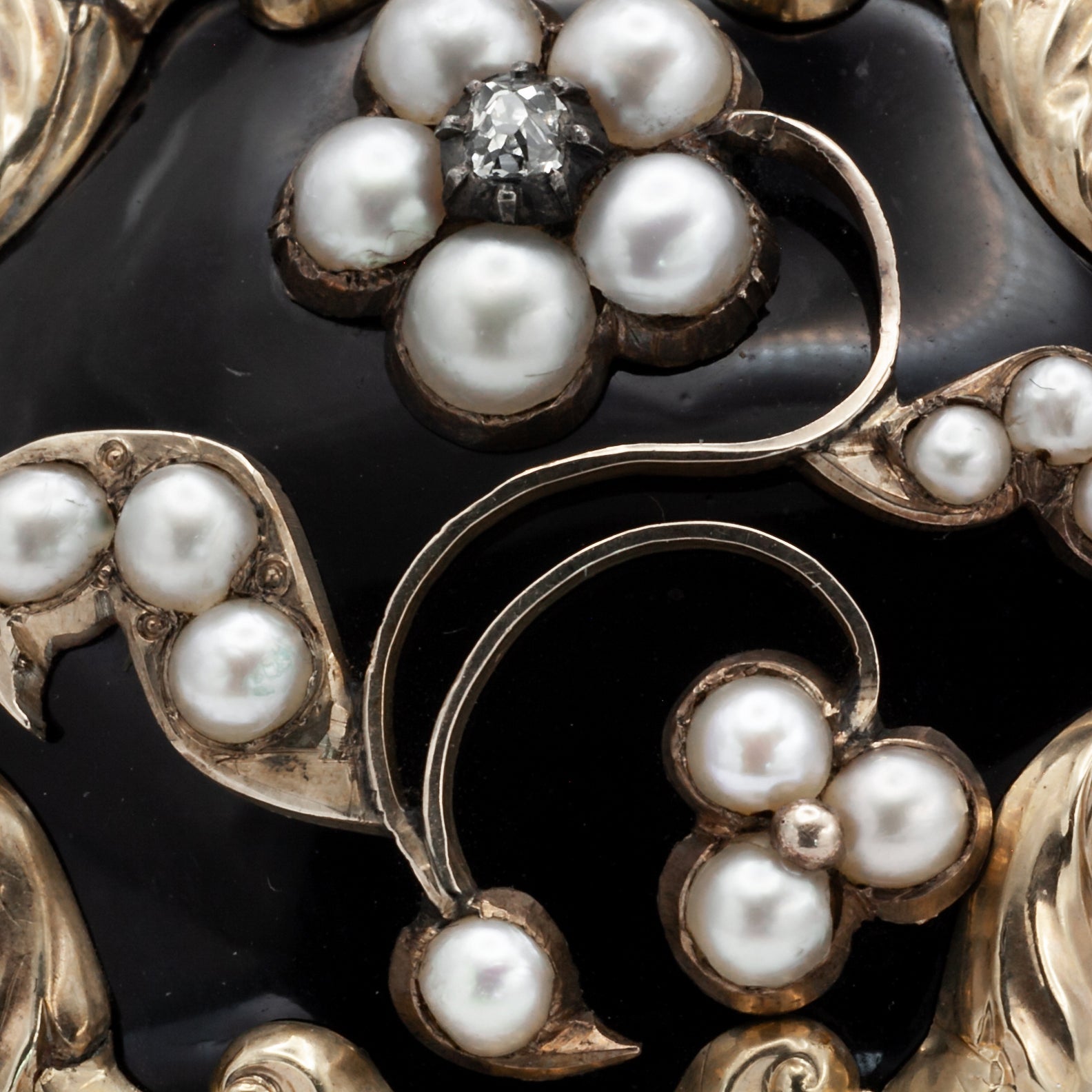 A Victorian diamond, onyx, and seed Pearl mourning brooch