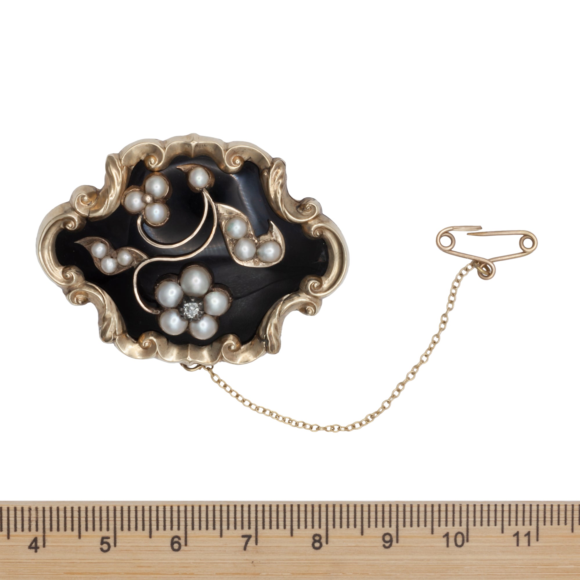 A Victorian diamond, onyx, and seed Pearl mourning brooch