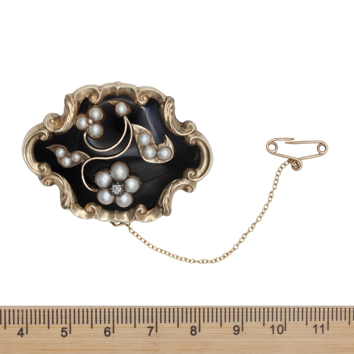 A Victorian diamond, onyx, and seed Pearl mourning brooch