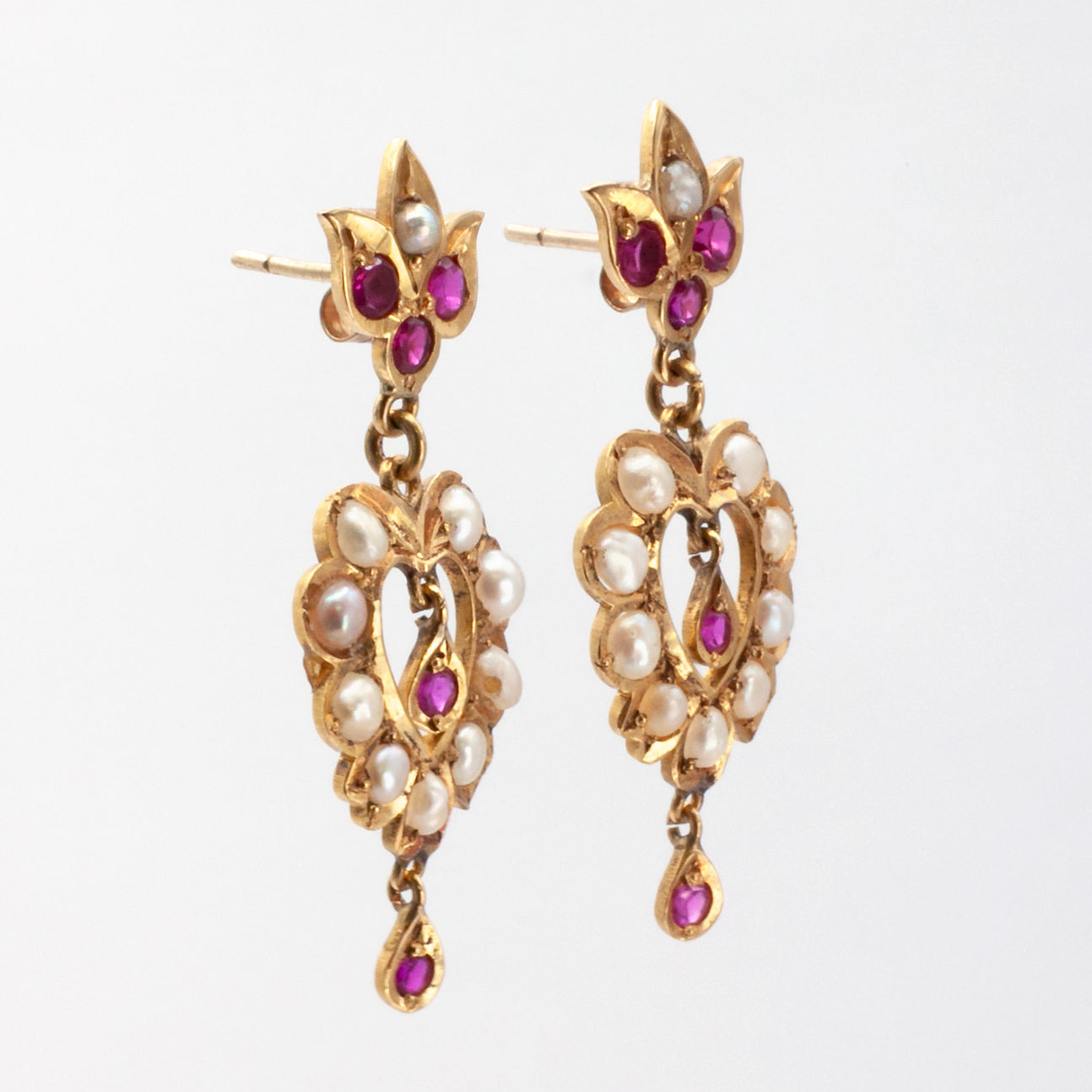 An antique pair of 9ct gold ruby and seed pearl earrings