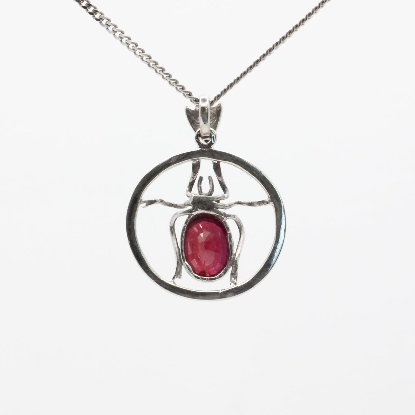 An antique 18ct white gold ruby and amber beetle pendant.