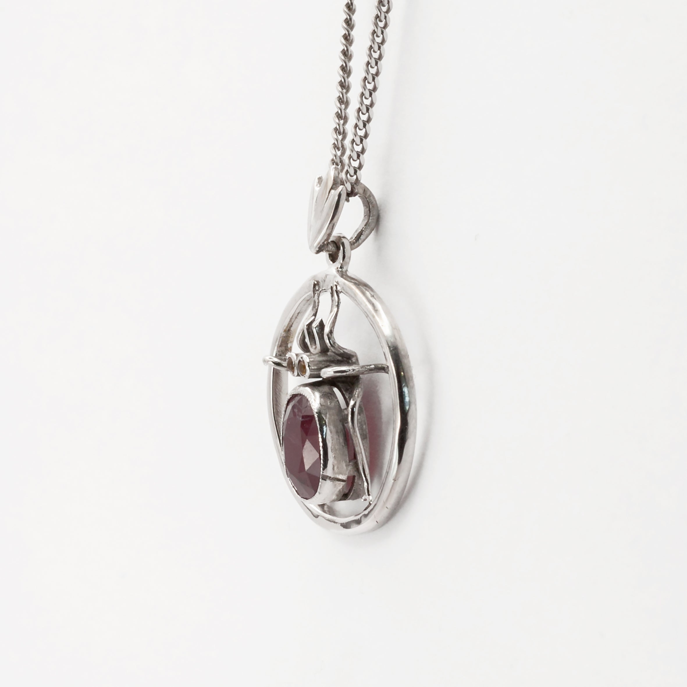 An antique 18ct white gold ruby and amber beetle pendant.