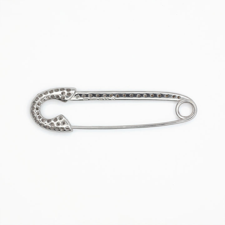An antique 18ct white gold diamond safety pin brooch.
