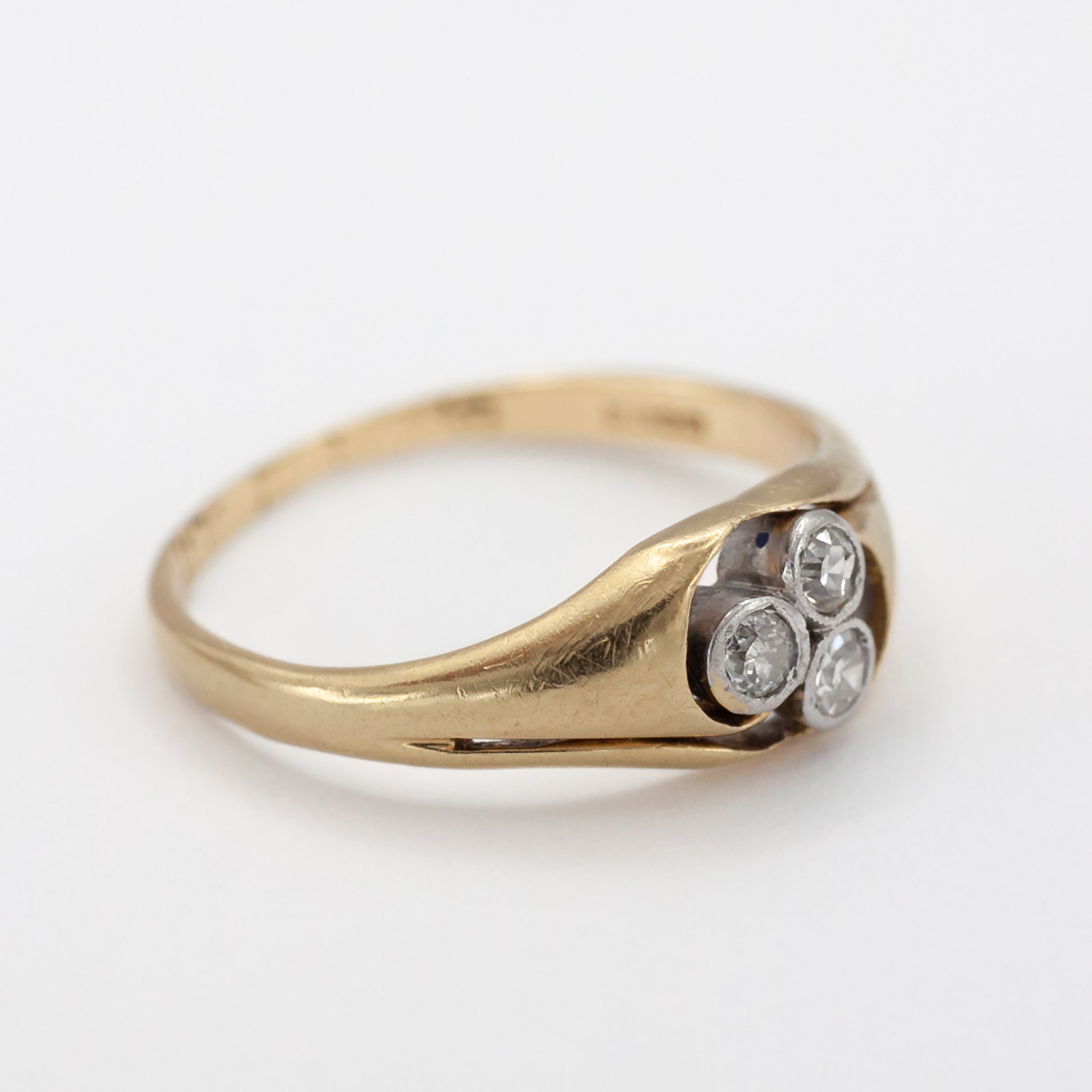 An 18ct gold and platinum three stone diamond ring