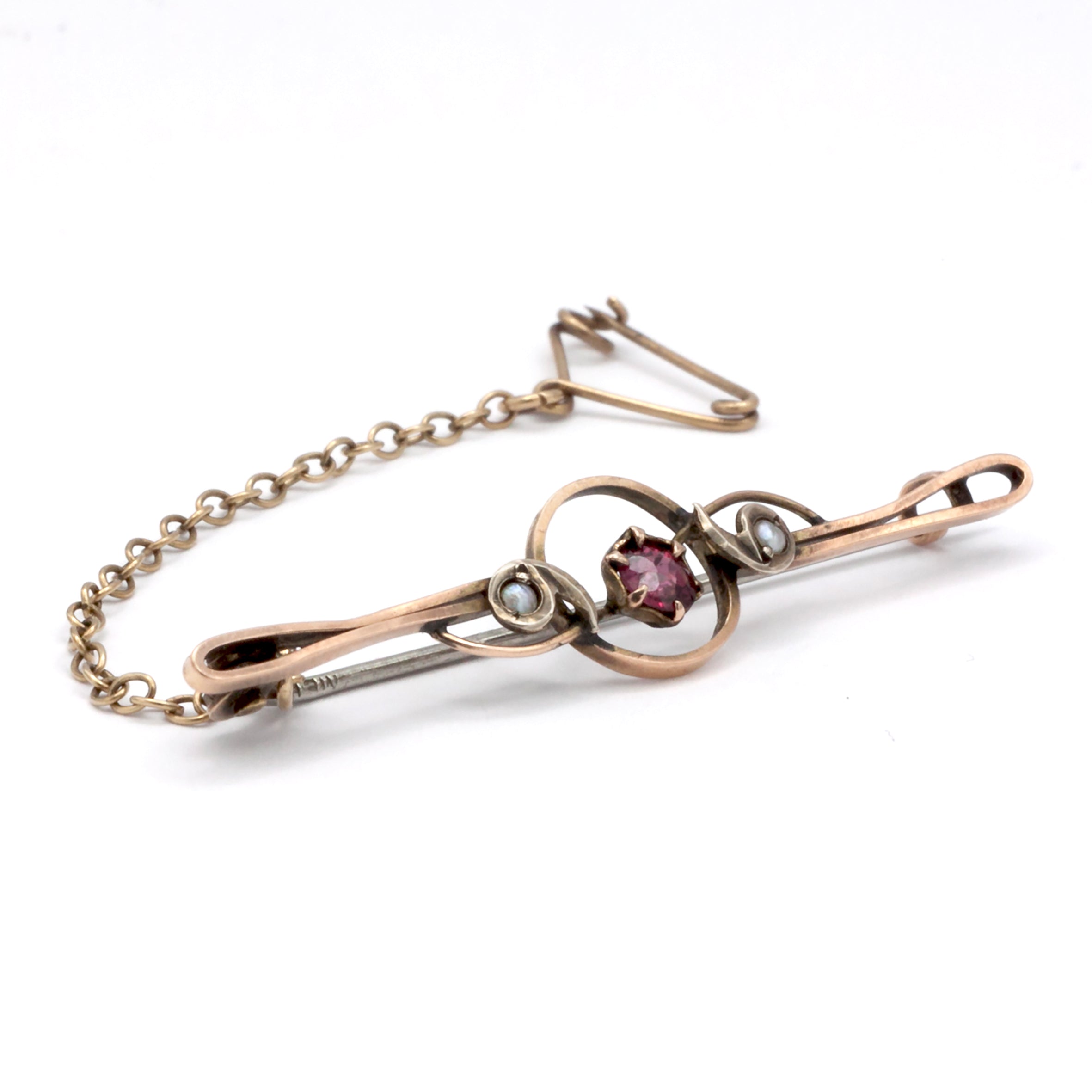 An antique 9ct gold ruby and pearl brooch