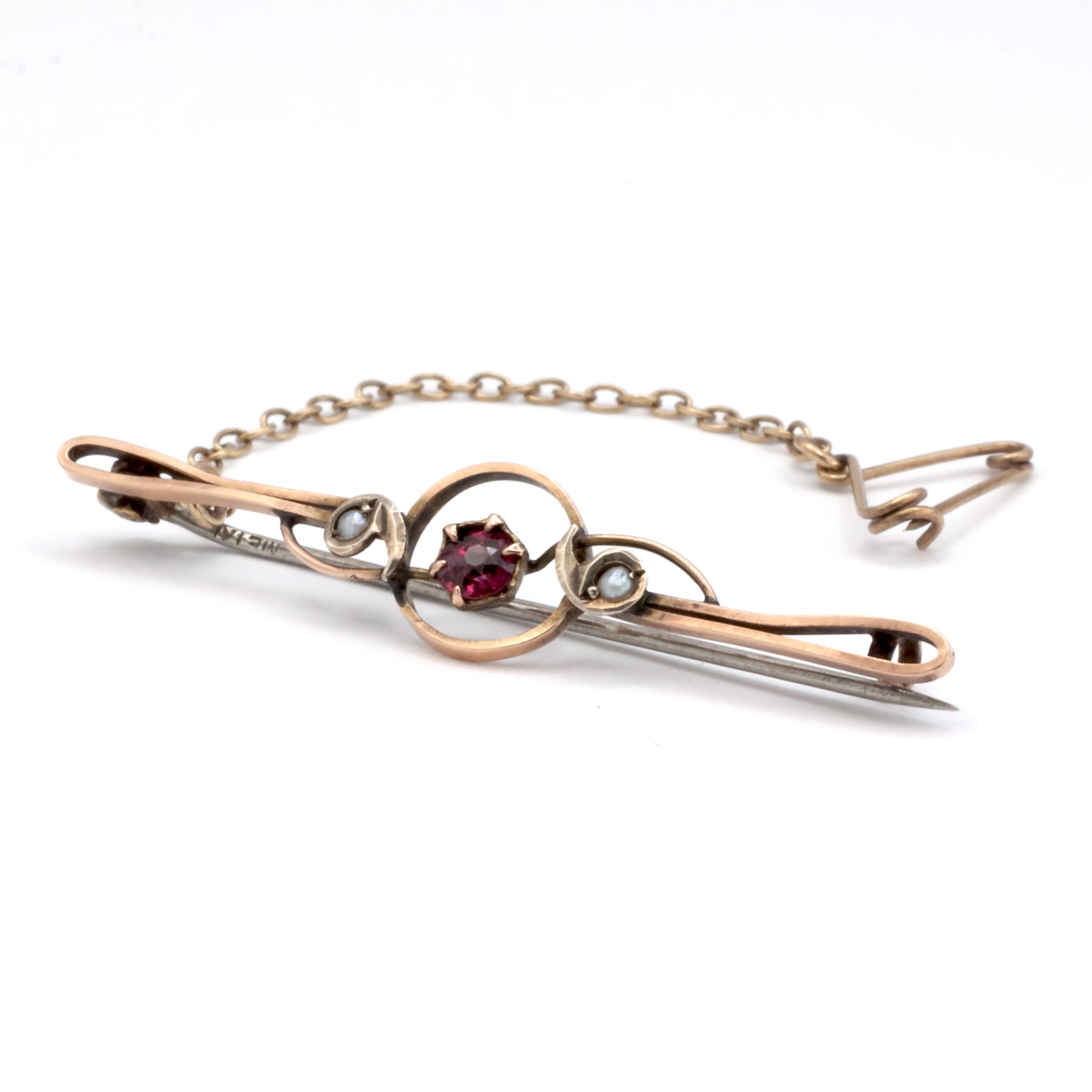 An antique 9ct gold ruby and pearl brooch