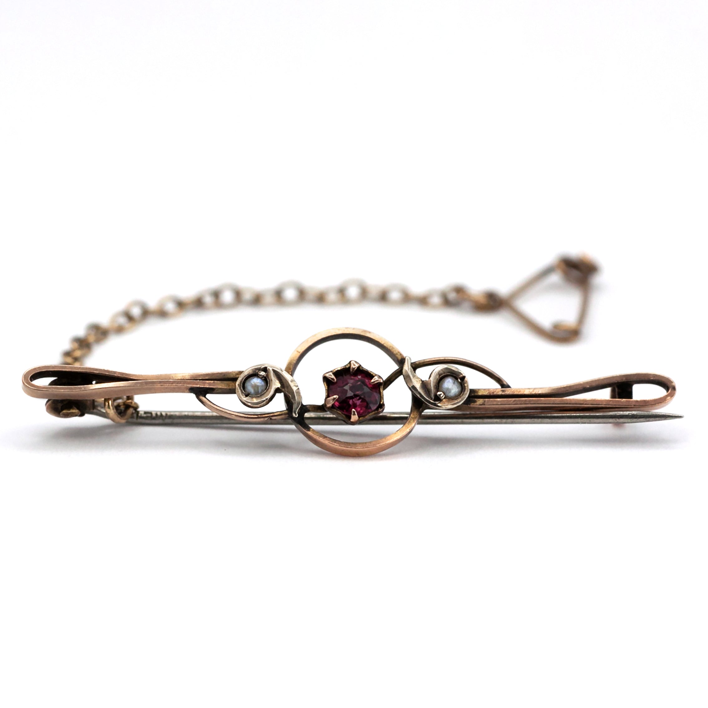 An antique 9ct gold ruby and pearl brooch