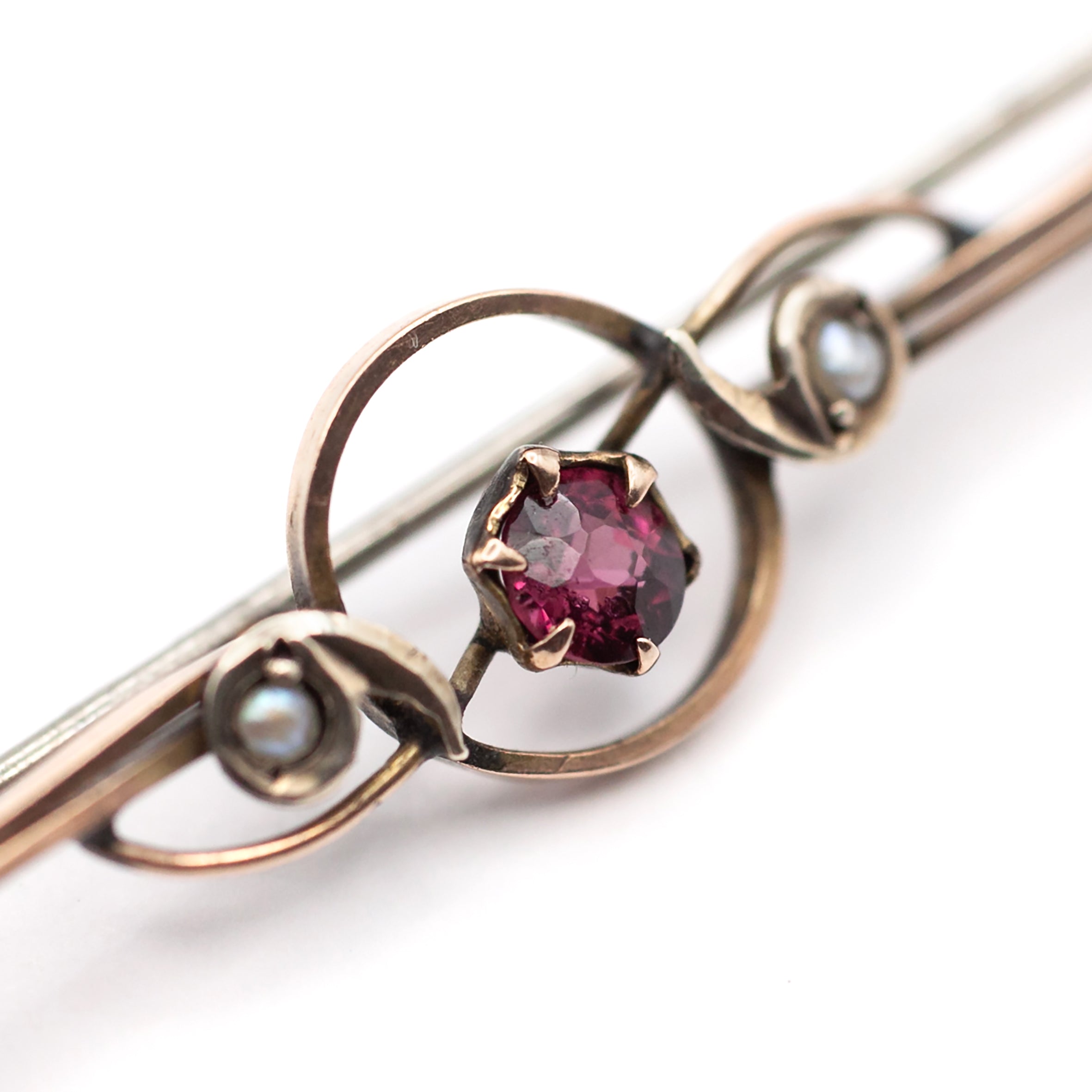 An antique 9ct gold ruby and pearl brooch