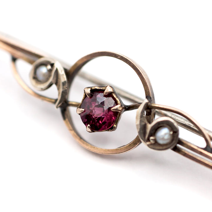 An antique 9ct gold ruby and pearl brooch
