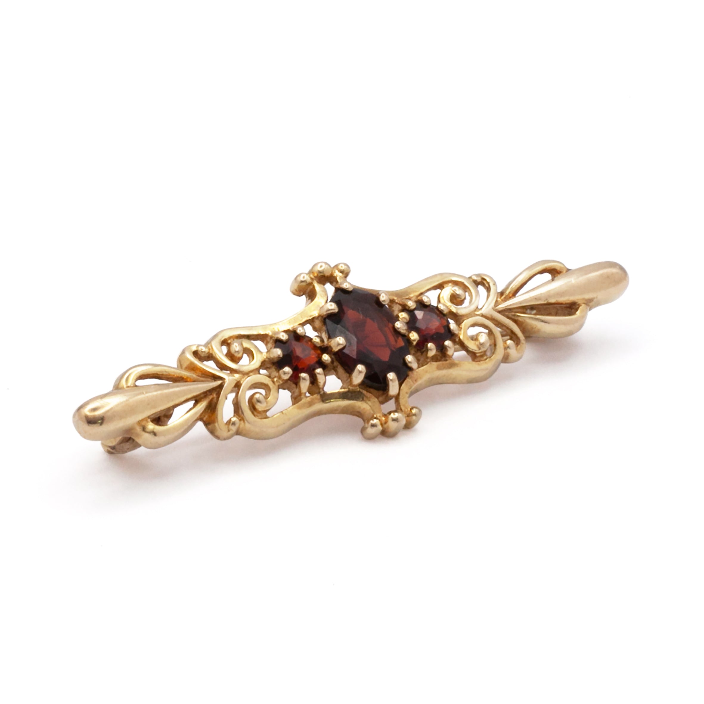 An antique 9ct gold garnet brooch