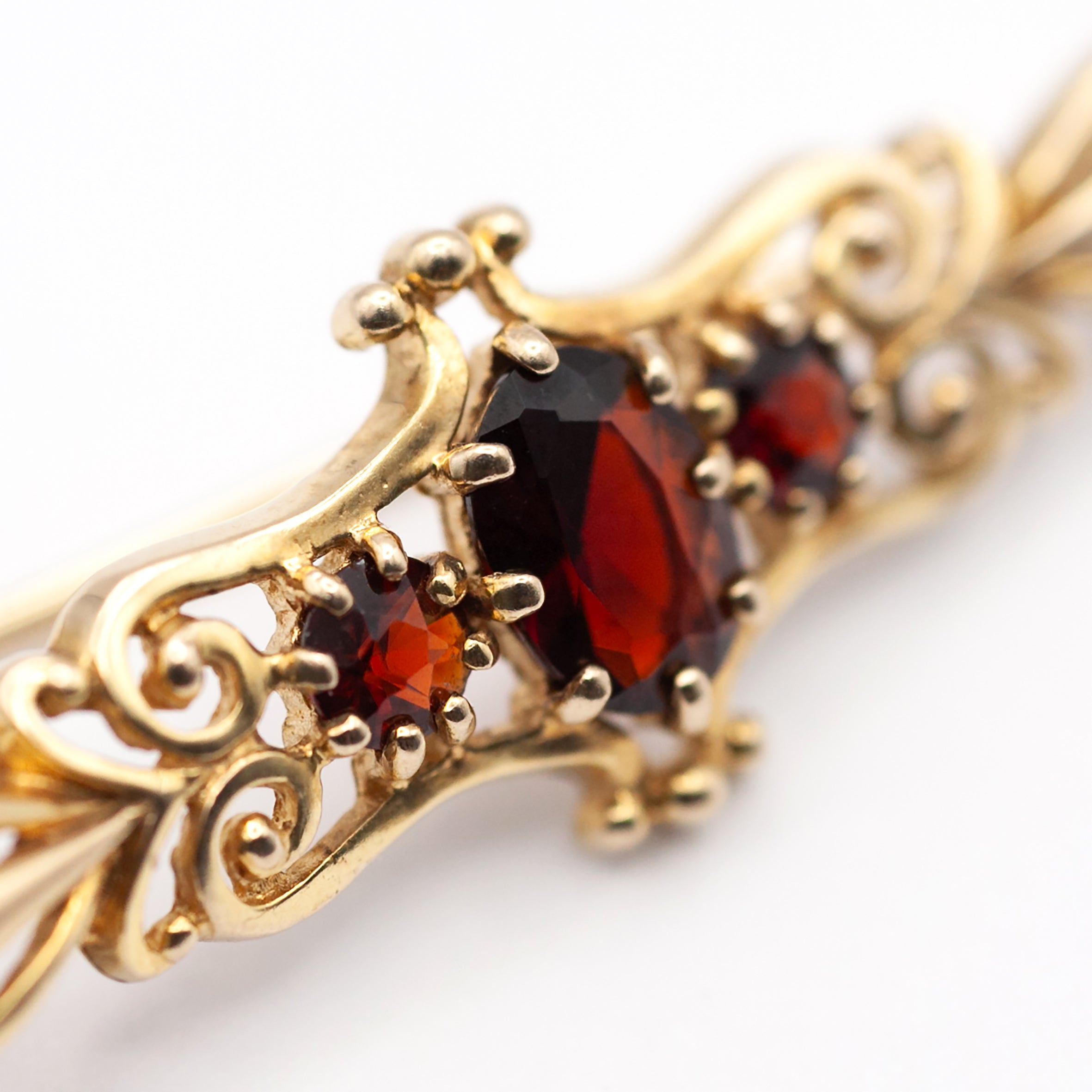 An antique 9ct gold garnet brooch