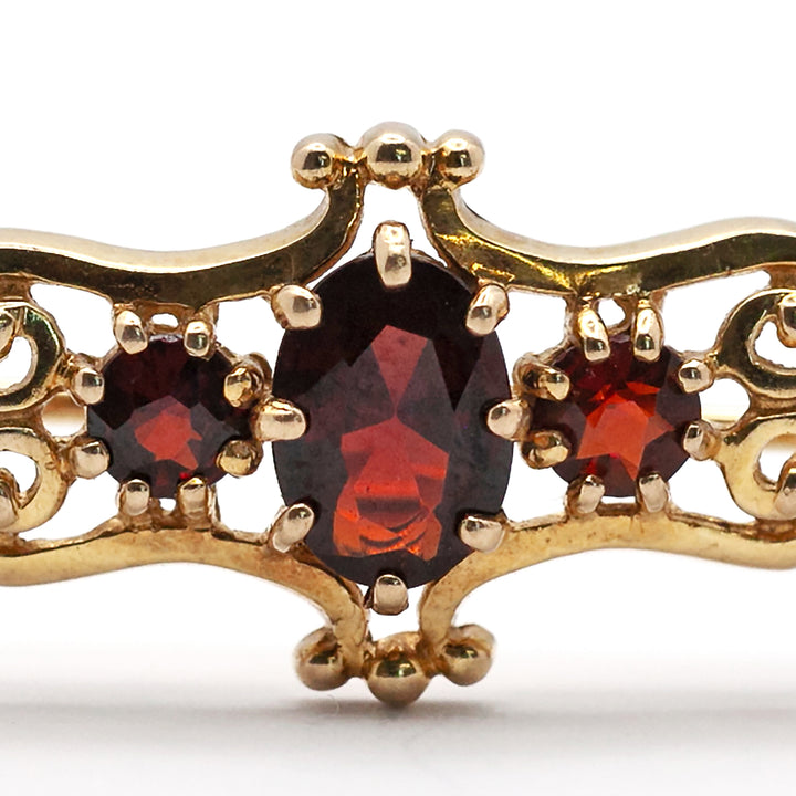 An antique 9ct gold garnet brooch