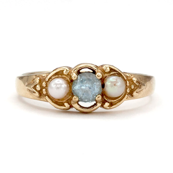 A 9ct gold topaz and pearl ring