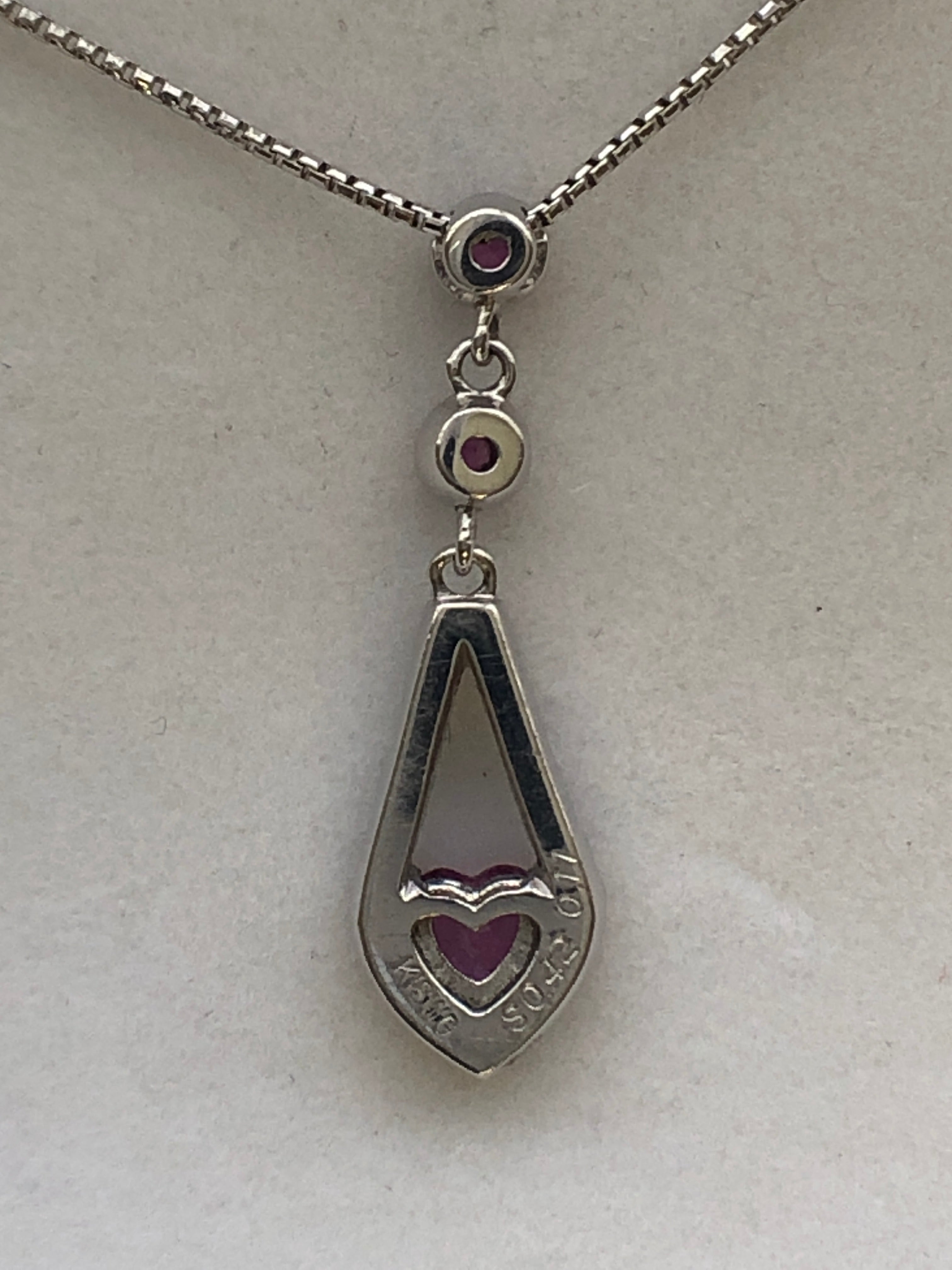 An 18ct white gold pink sapphire and diamond pendant