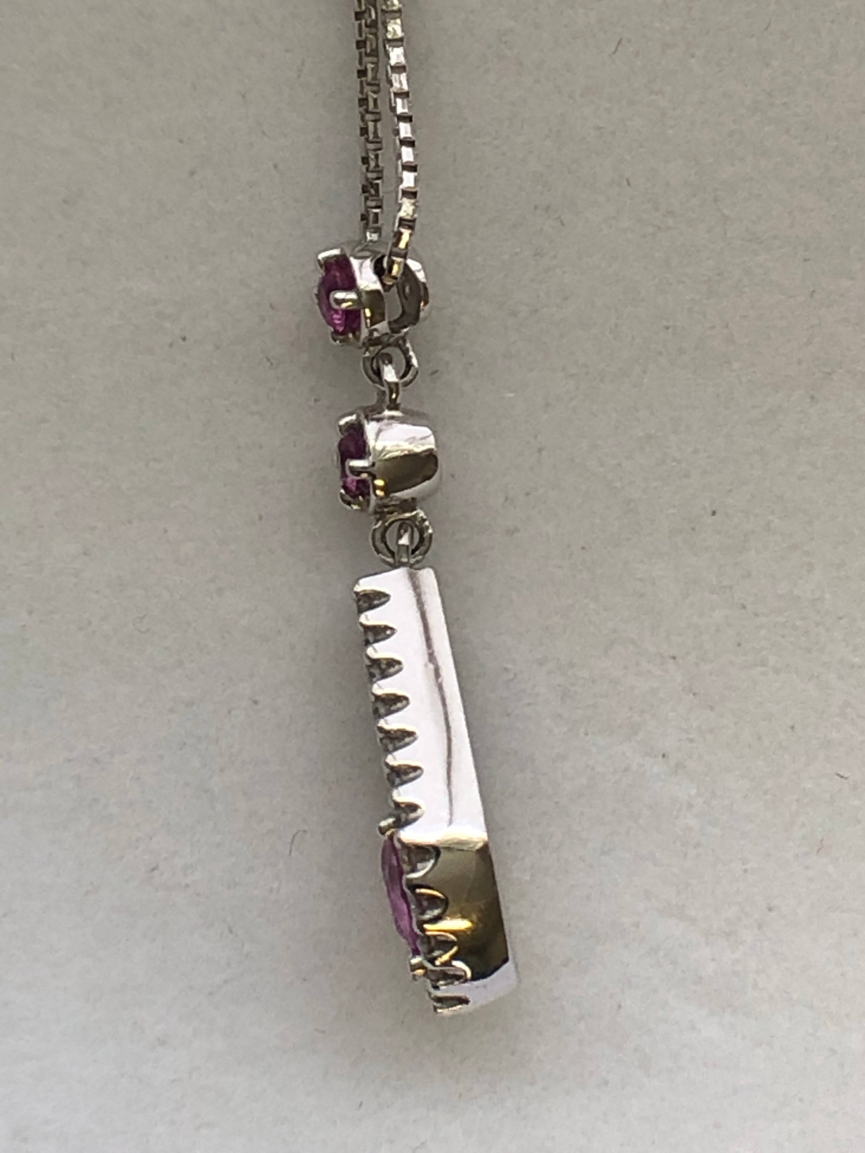 An 18ct white gold pink sapphire and diamond pendant