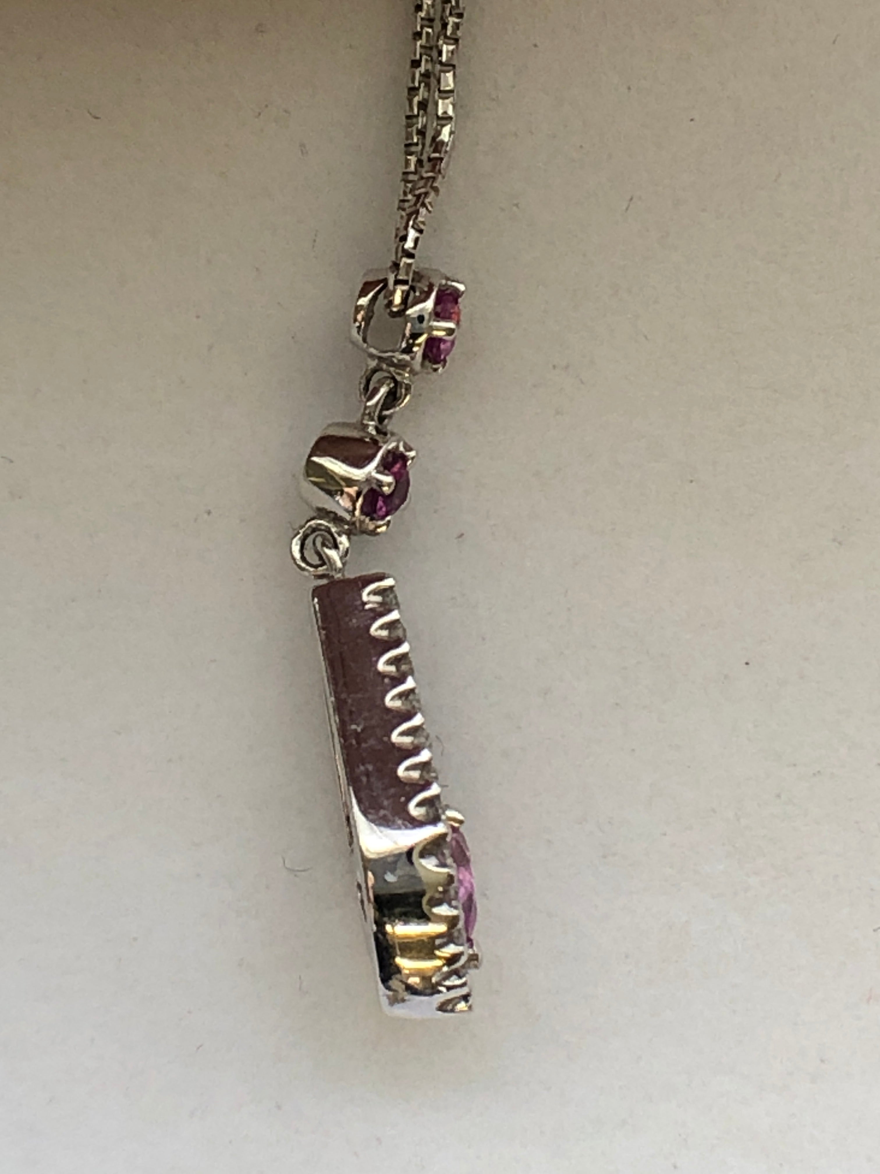 An 18ct white gold pink sapphire and diamond pendant