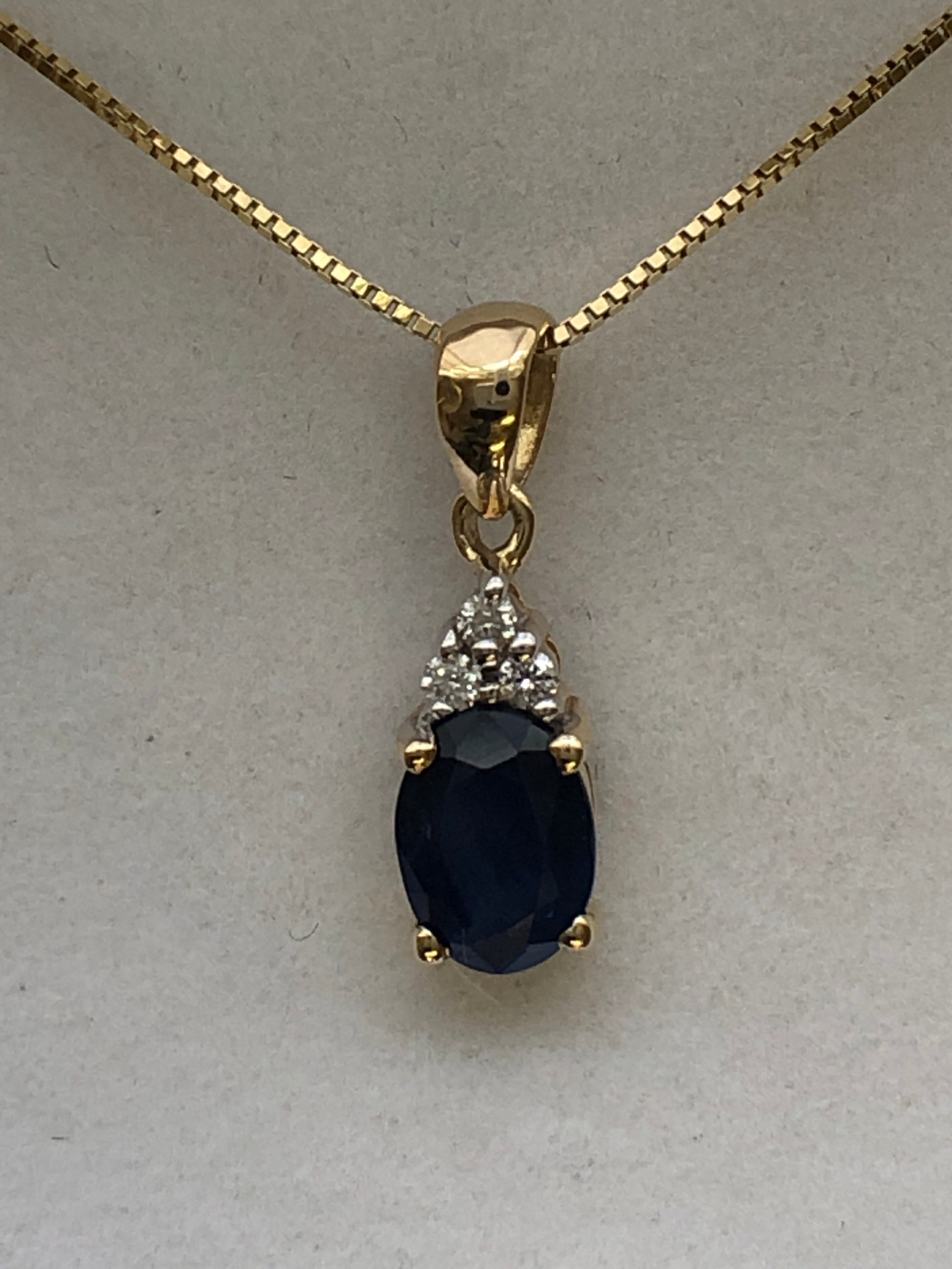 A 9ct gold sapphire and diamond pendant