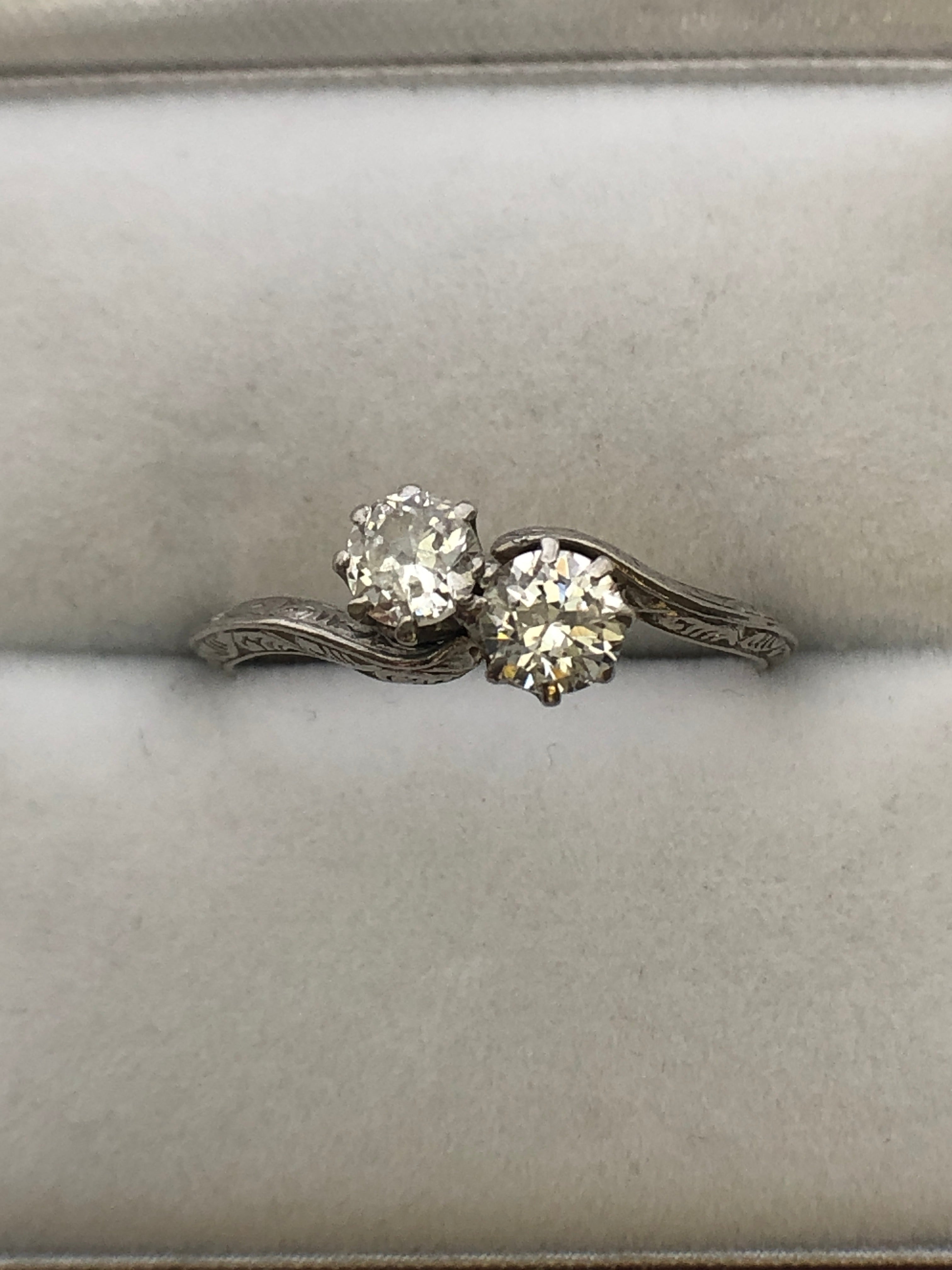 An antique platinum and diamond two stone twist ring