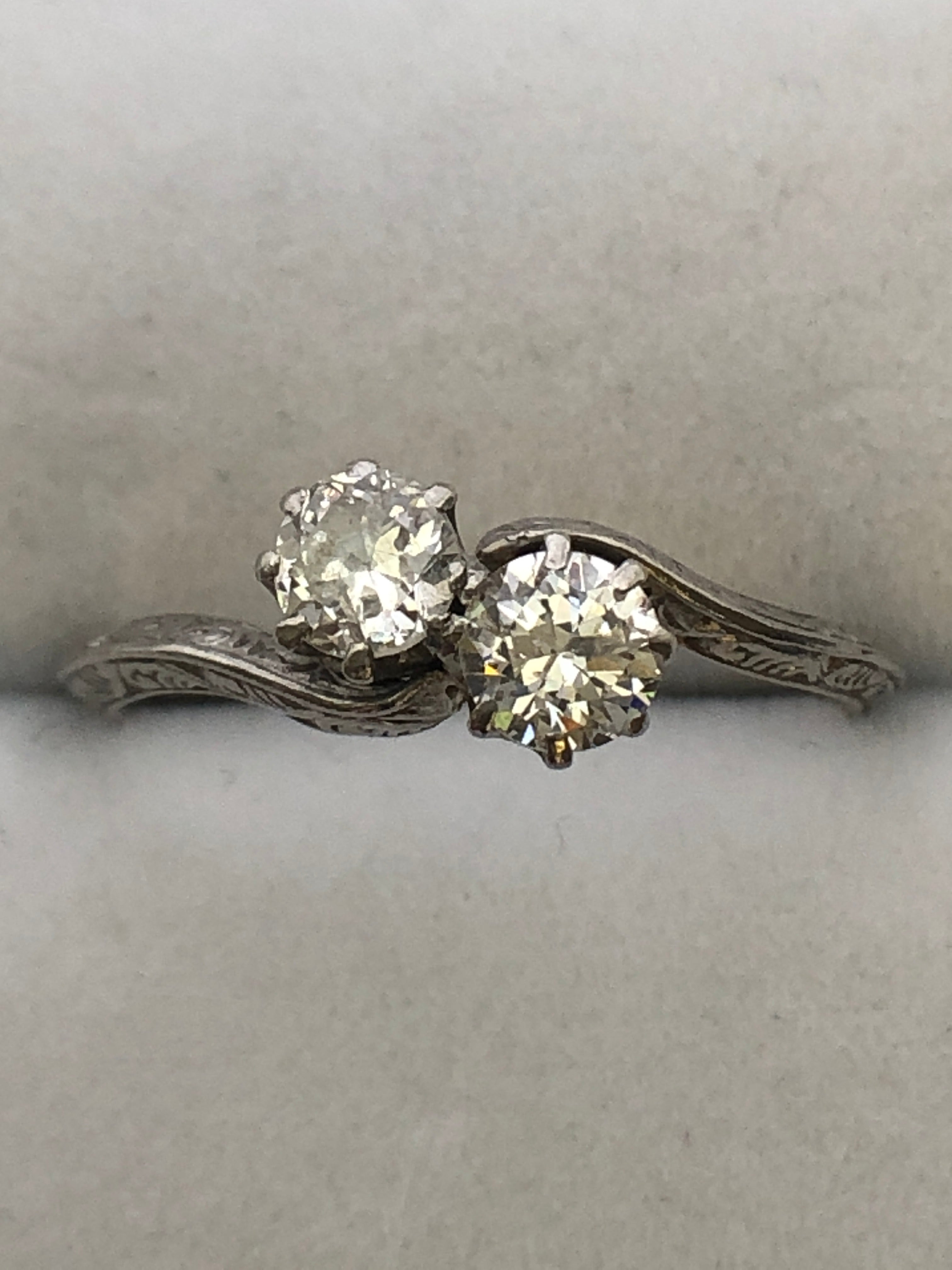 An antique platinum and diamond two stone twist ring