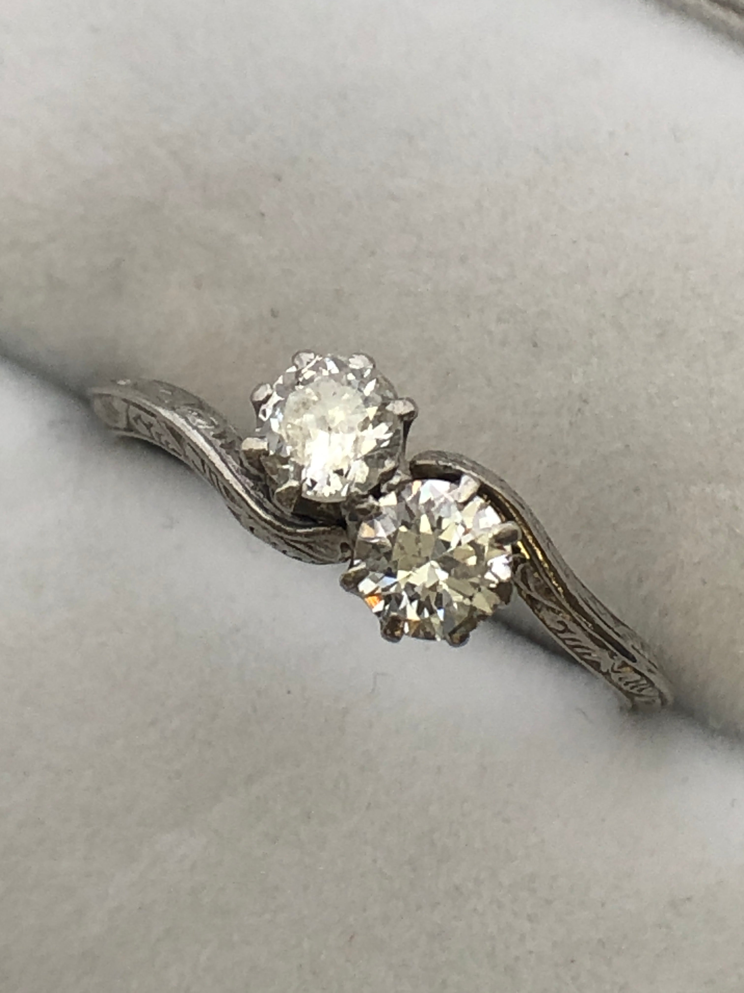 An antique platinum and diamond two stone twist ring