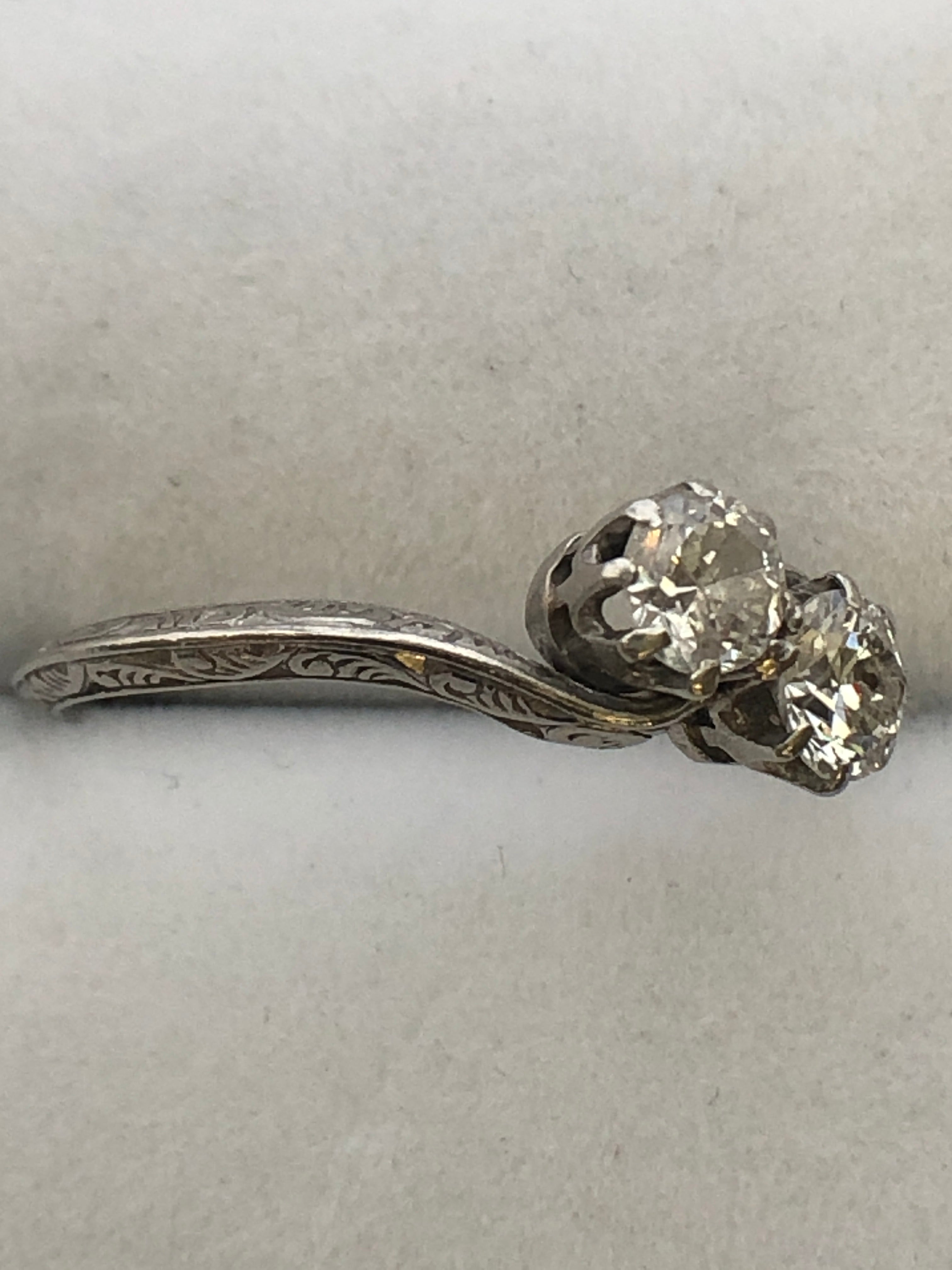 An antique platinum and diamond two stone twist ring