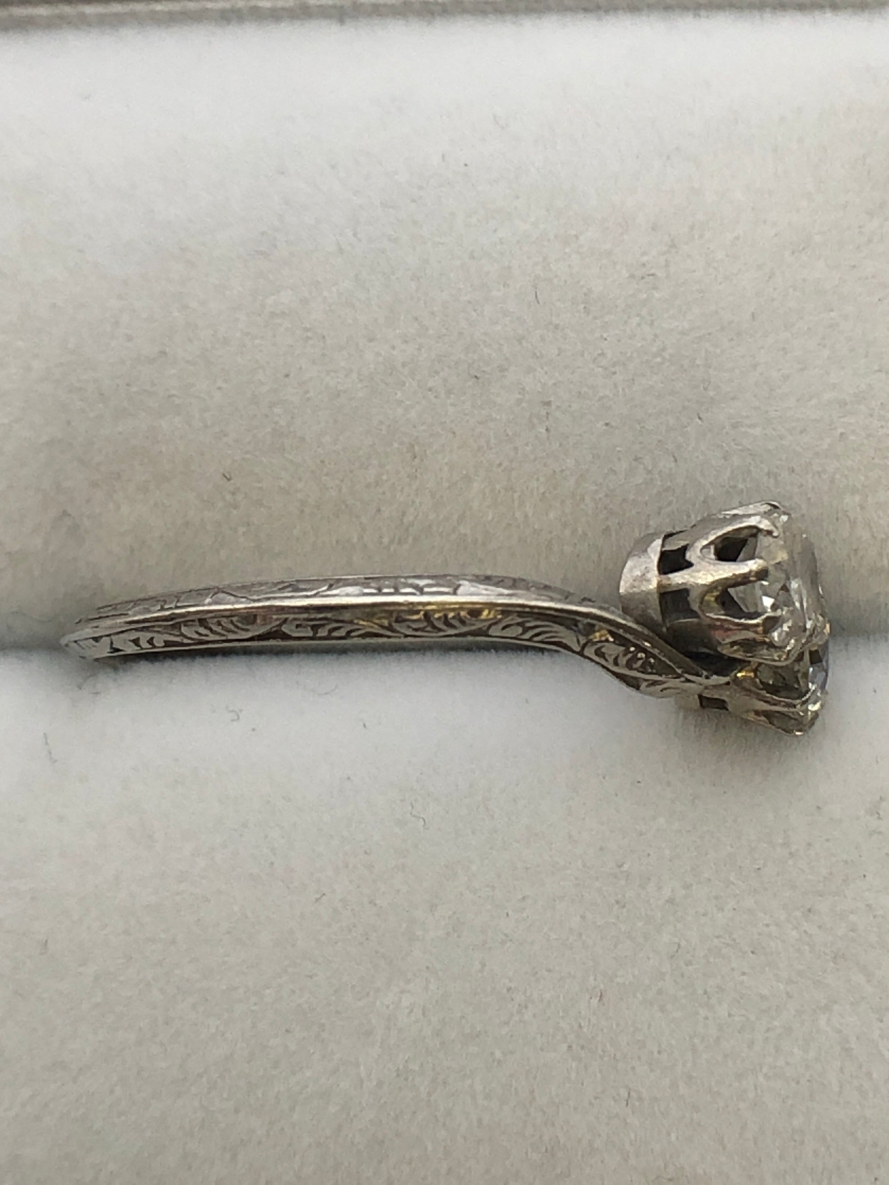 An antique platinum and diamond two stone twist ring