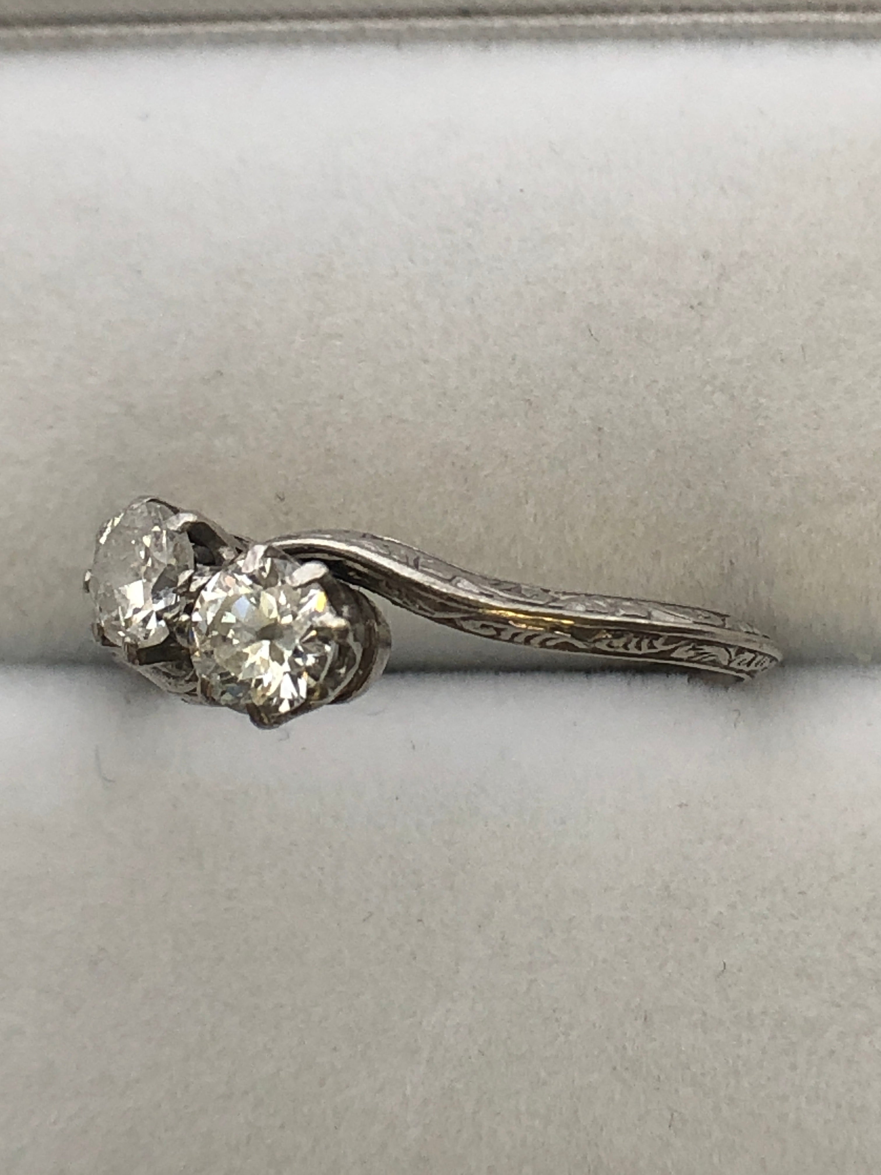 An antique platinum and diamond two stone twist ring
