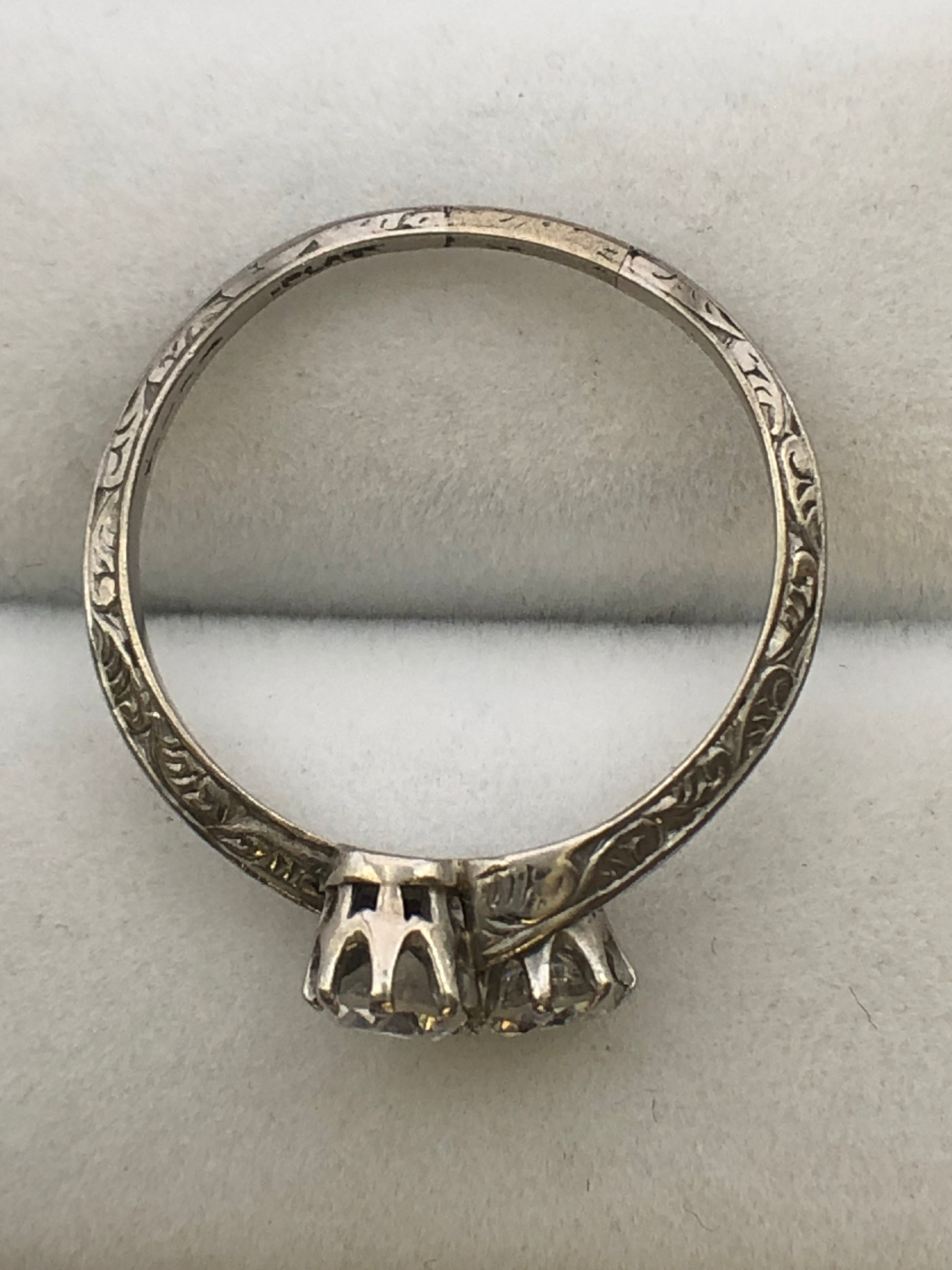 An antique platinum and diamond two stone twist ring