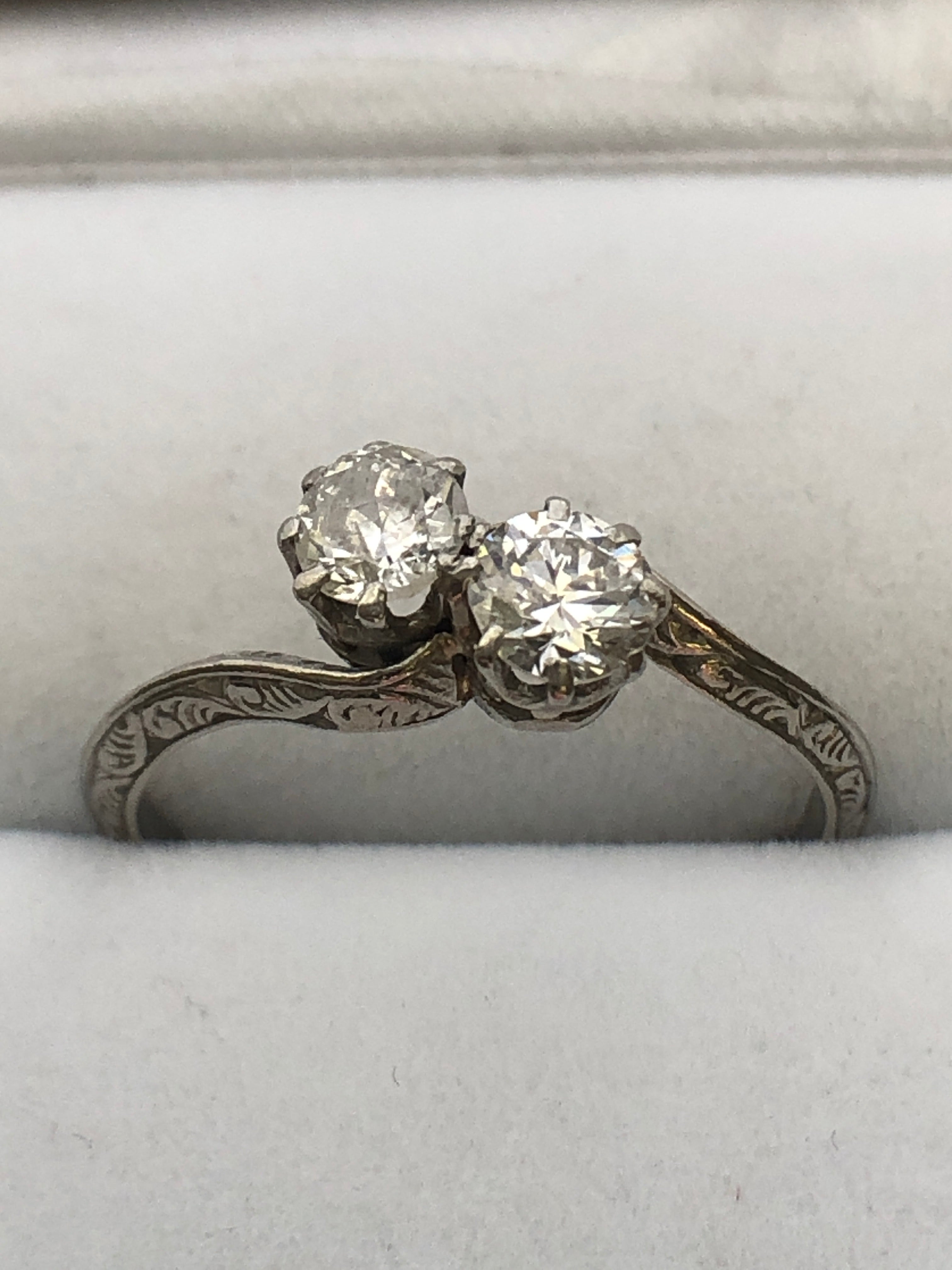 An antique platinum and diamond two stone twist ring