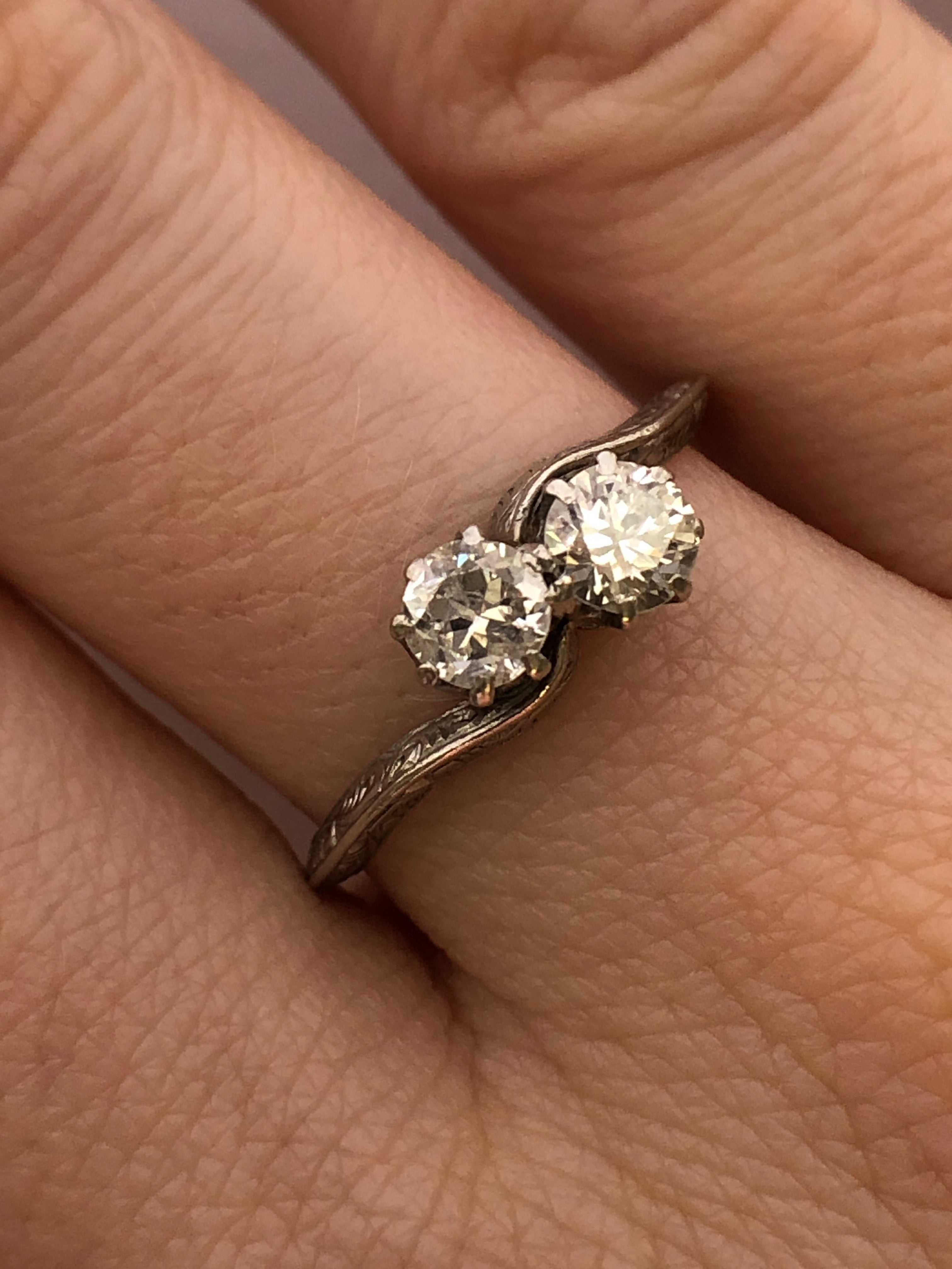 An antique platinum and diamond two stone twist ring